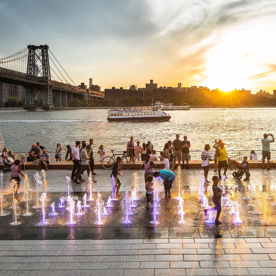 People hanging out in Domino Park in Brooklyn
