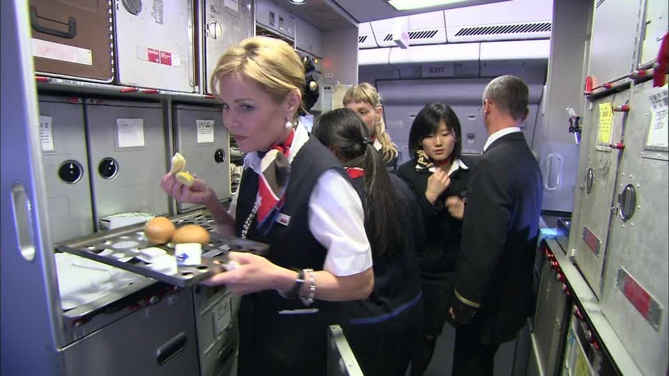 Flight attendant holding food