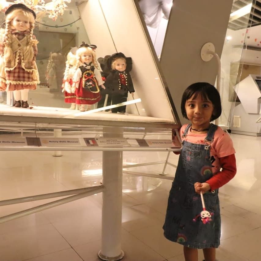 A kid at a doll museum