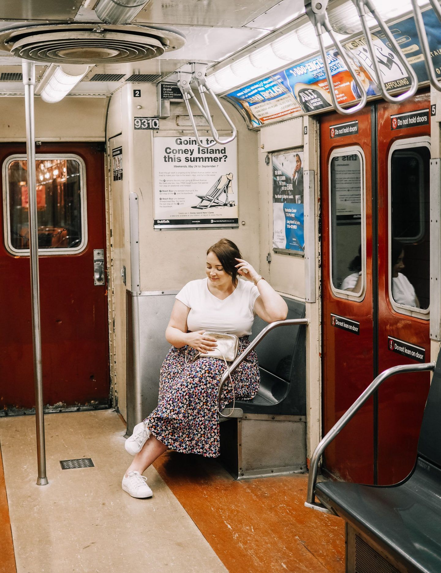 Girl sitting inside New York City subway