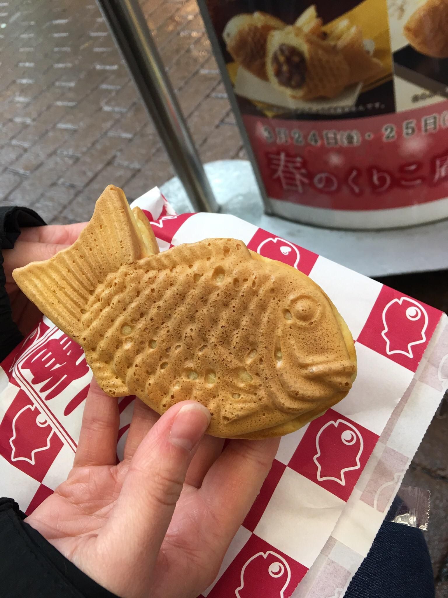 hand holding out Taiyaki in japan