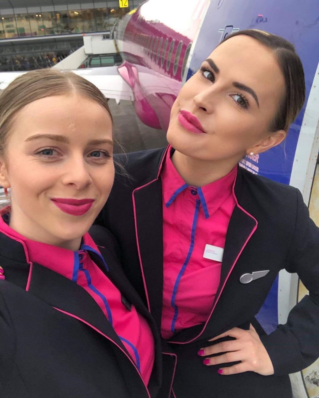 Two flight attendants near an airplane