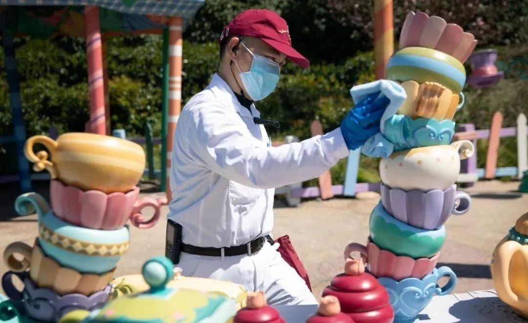 an employee sanitizes the rides at shanghai disneyland