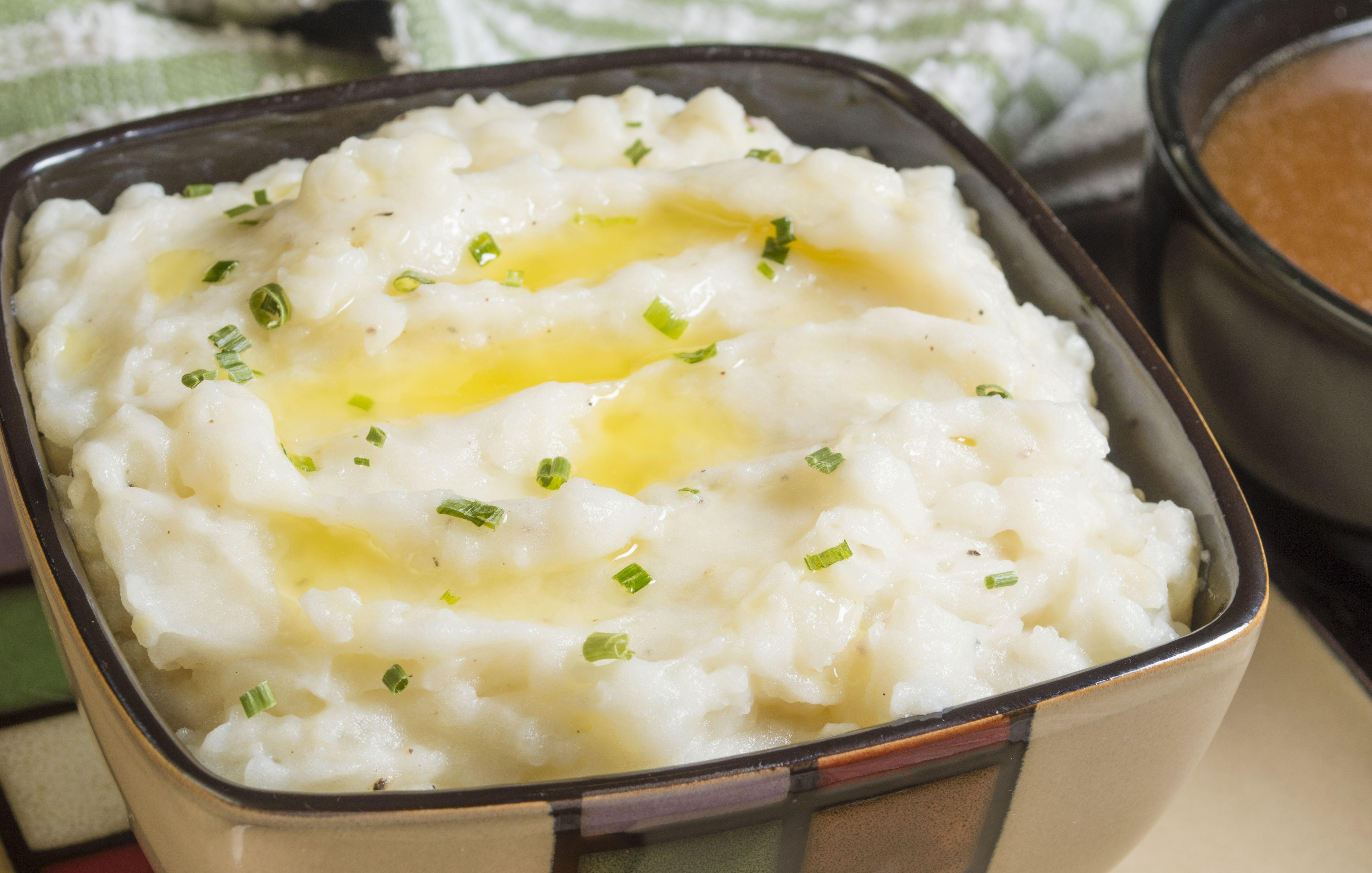  a bowl of mashed potatoes with butter
