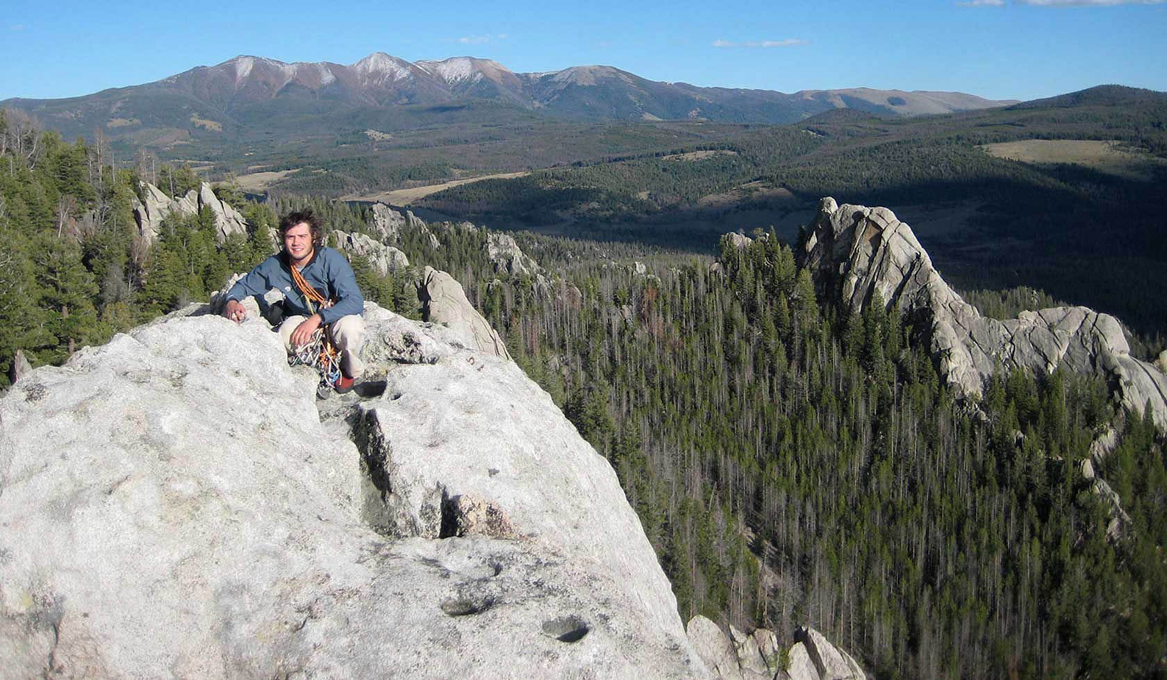 a man at the summit of humbug spires wilderness area in montana