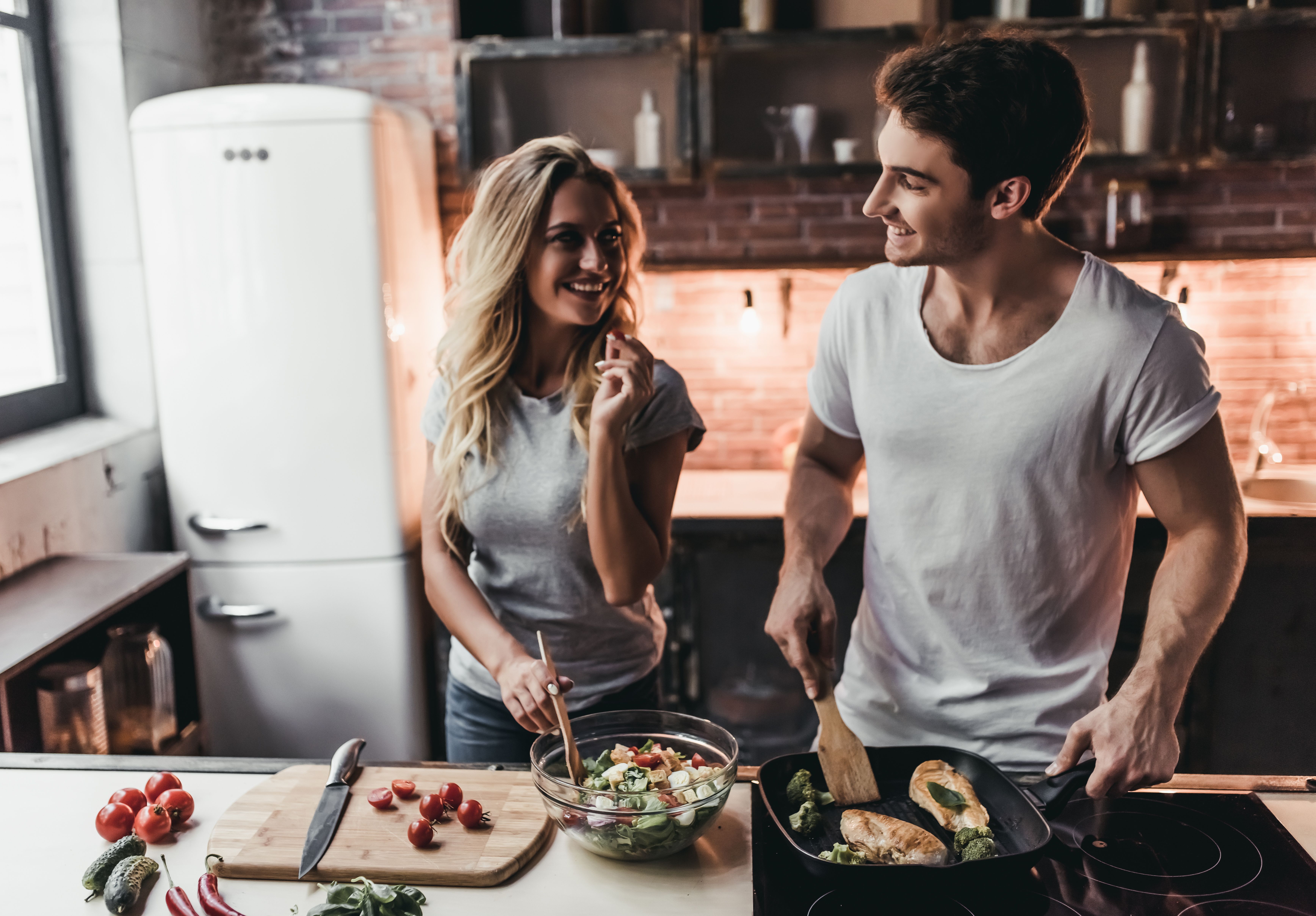 A couple cooking dinner