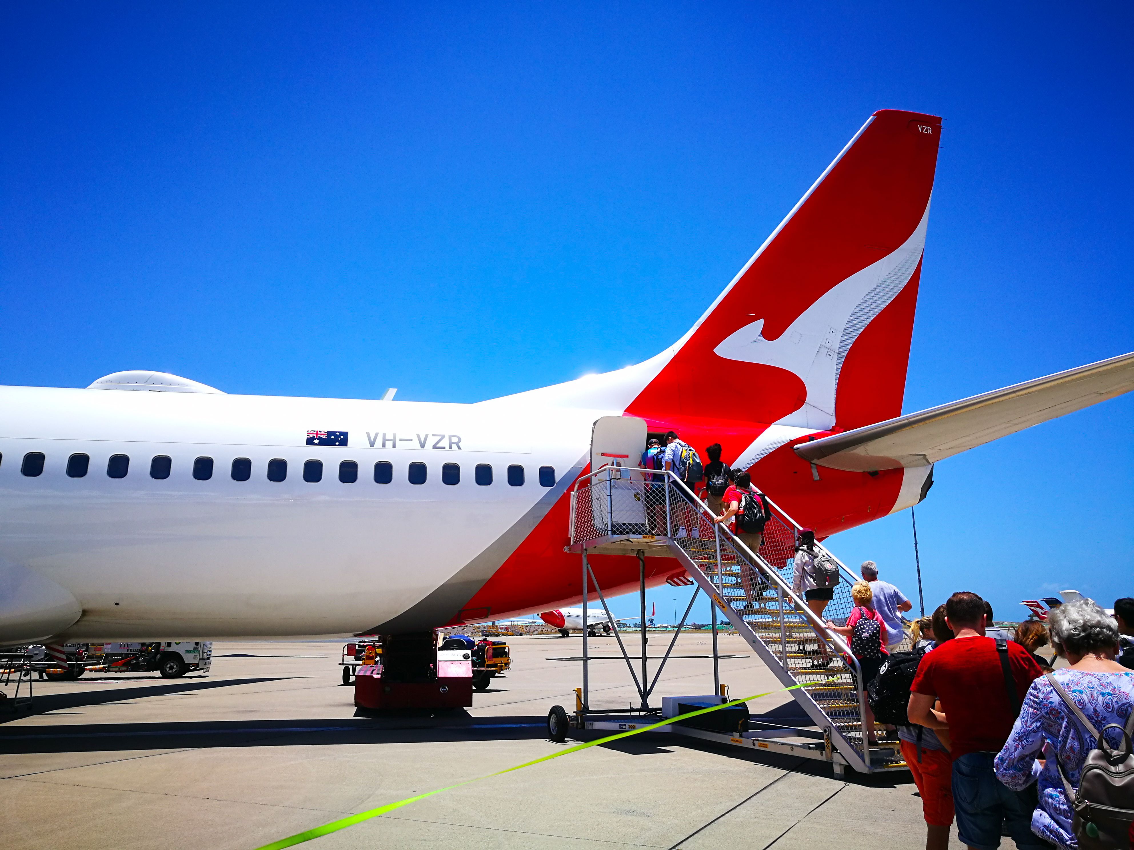 people boarding a qantas plane