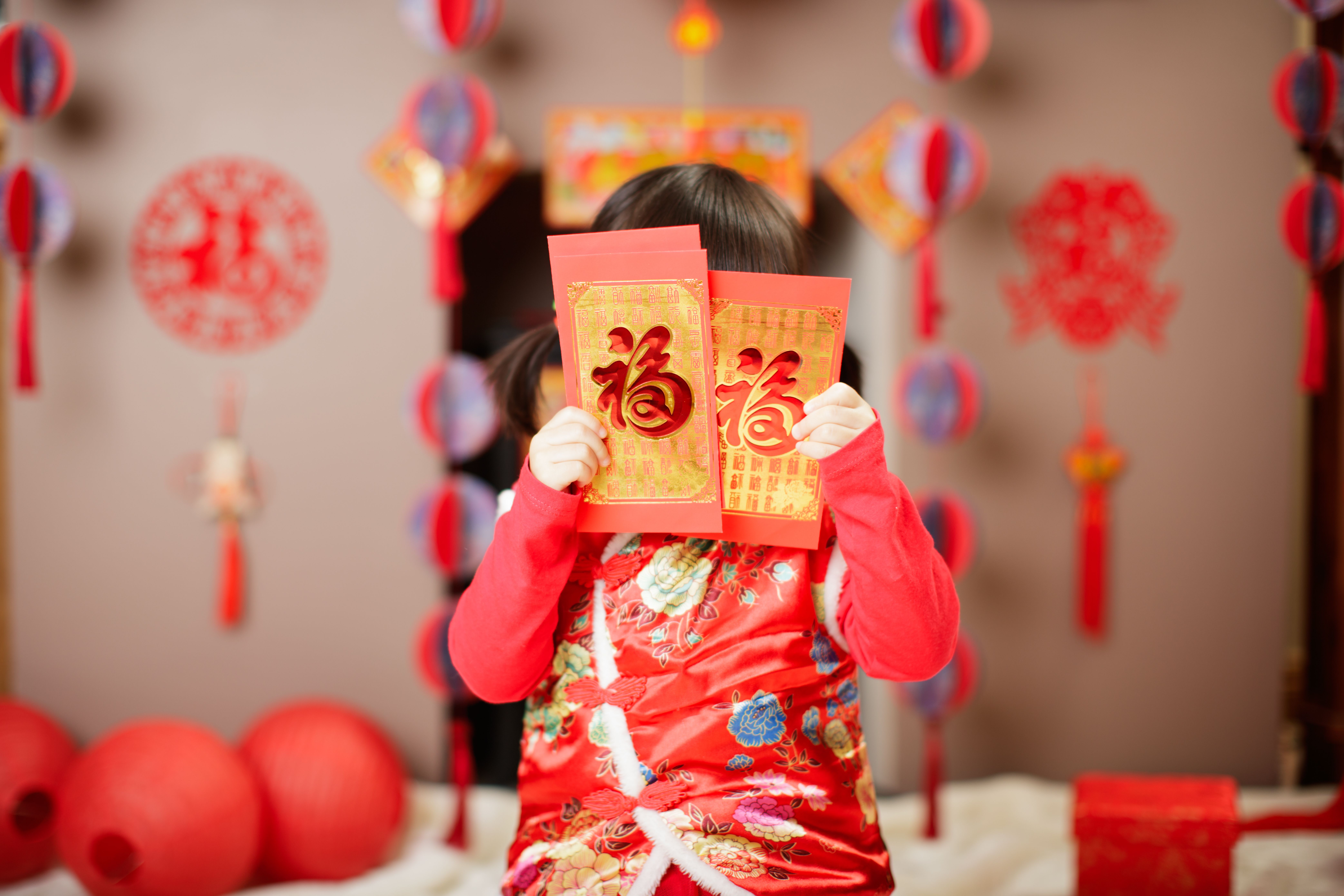 a child with red envelopes for lunar new year