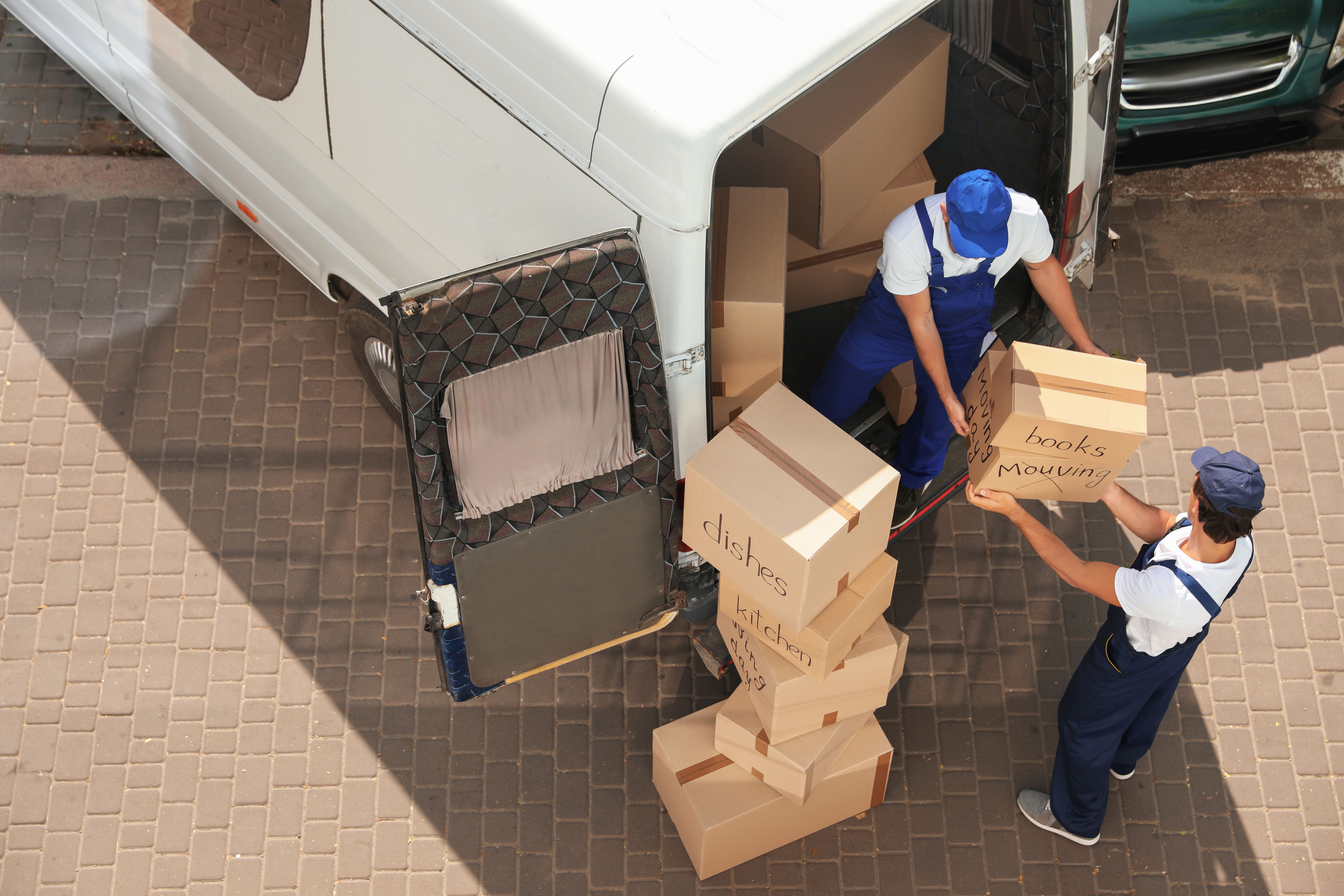 a moving company loading boxes into a van