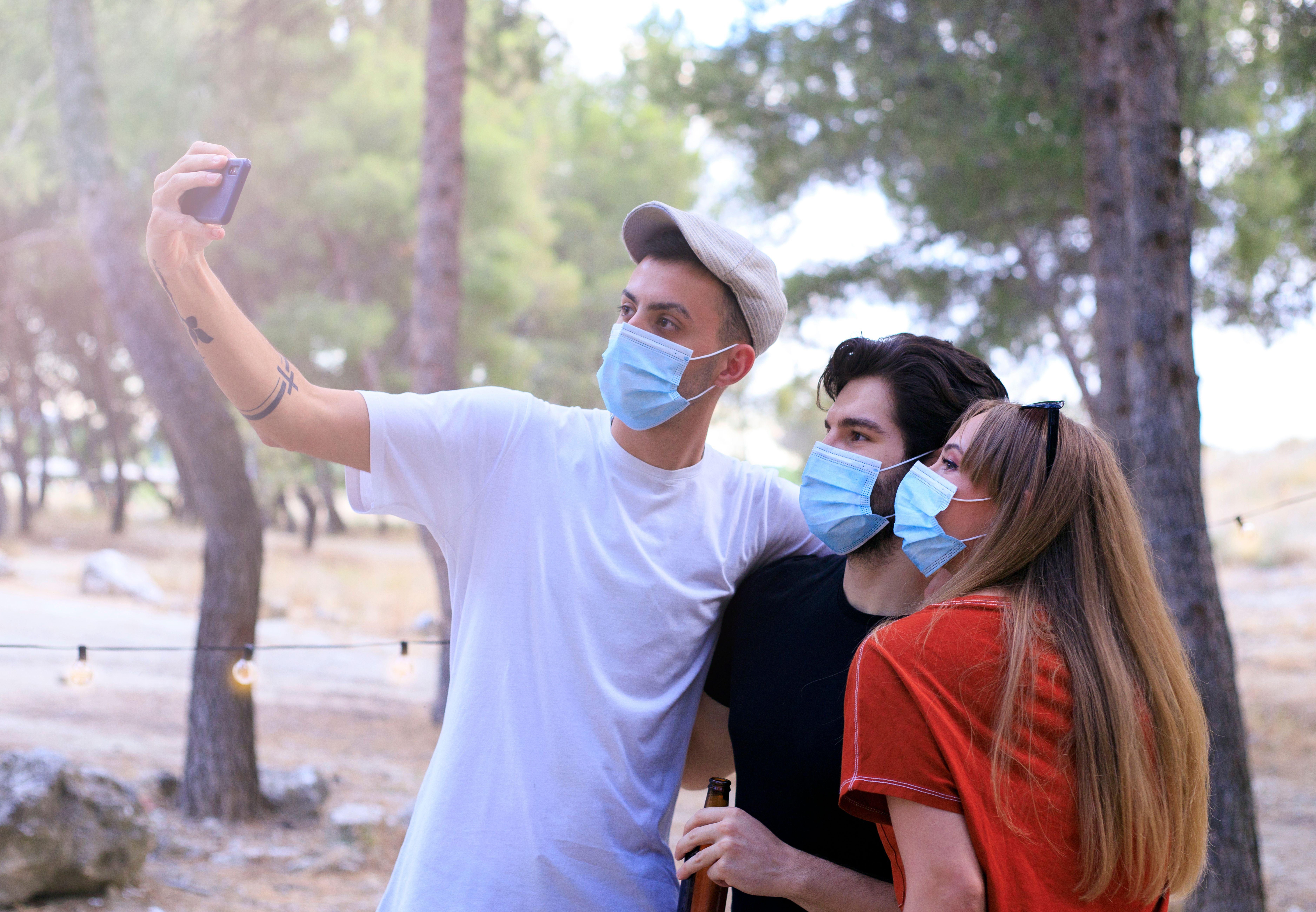 friends wearing face masks taking a selfie