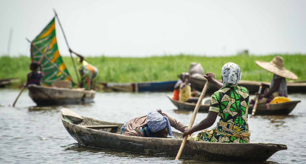 Beninese woman rows a fishing boat