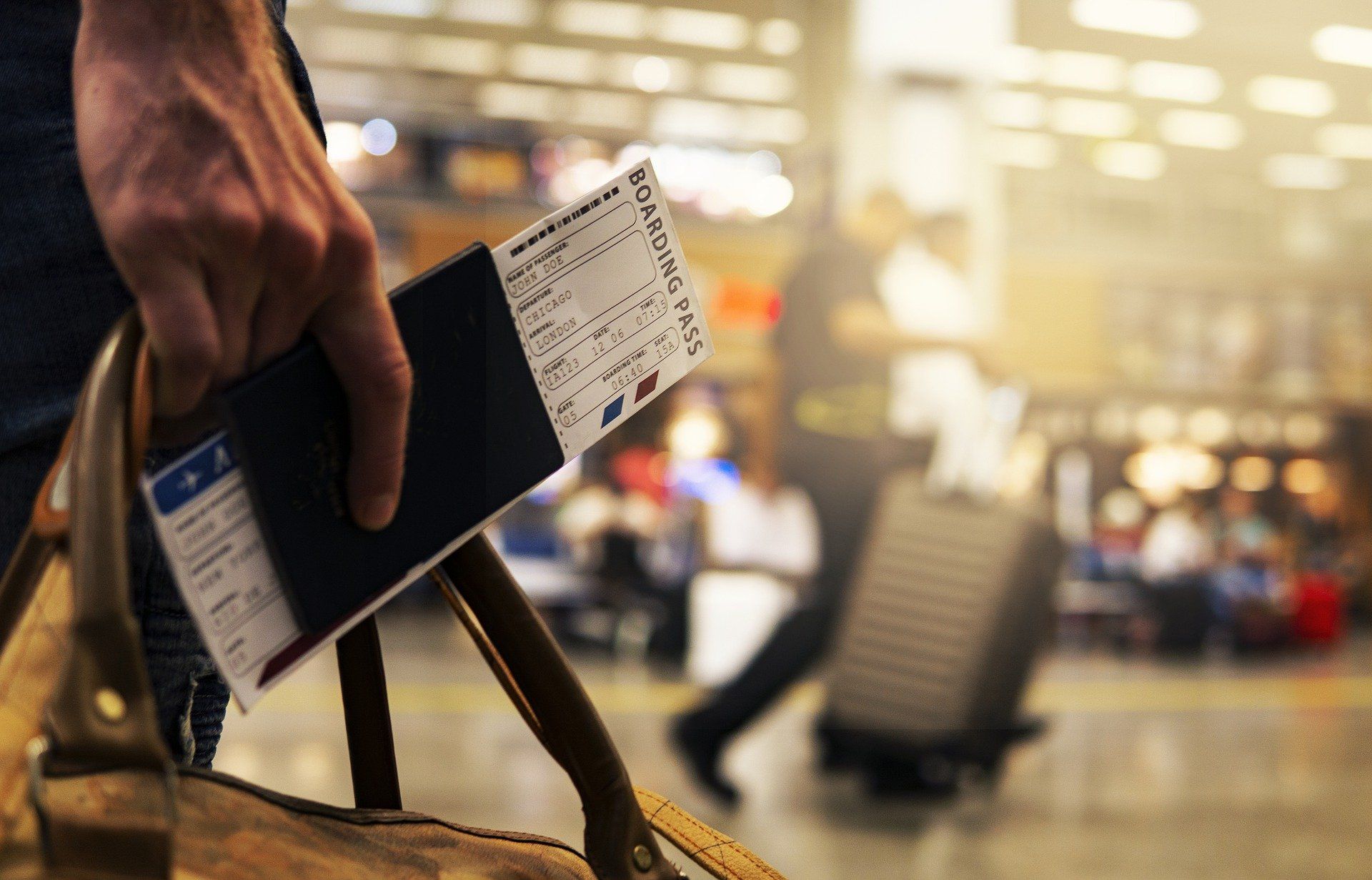 traveler holding boarding pass in airport