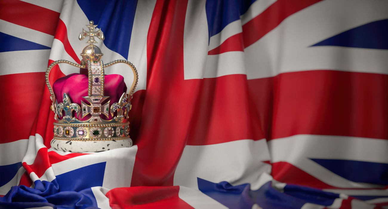 Royal golden crown with jewels on british flag