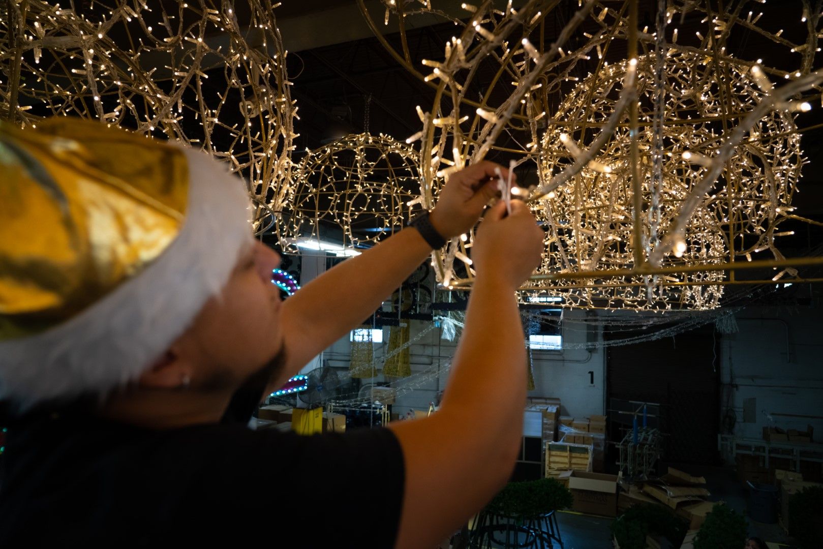stringing up lights for a display by american christmas