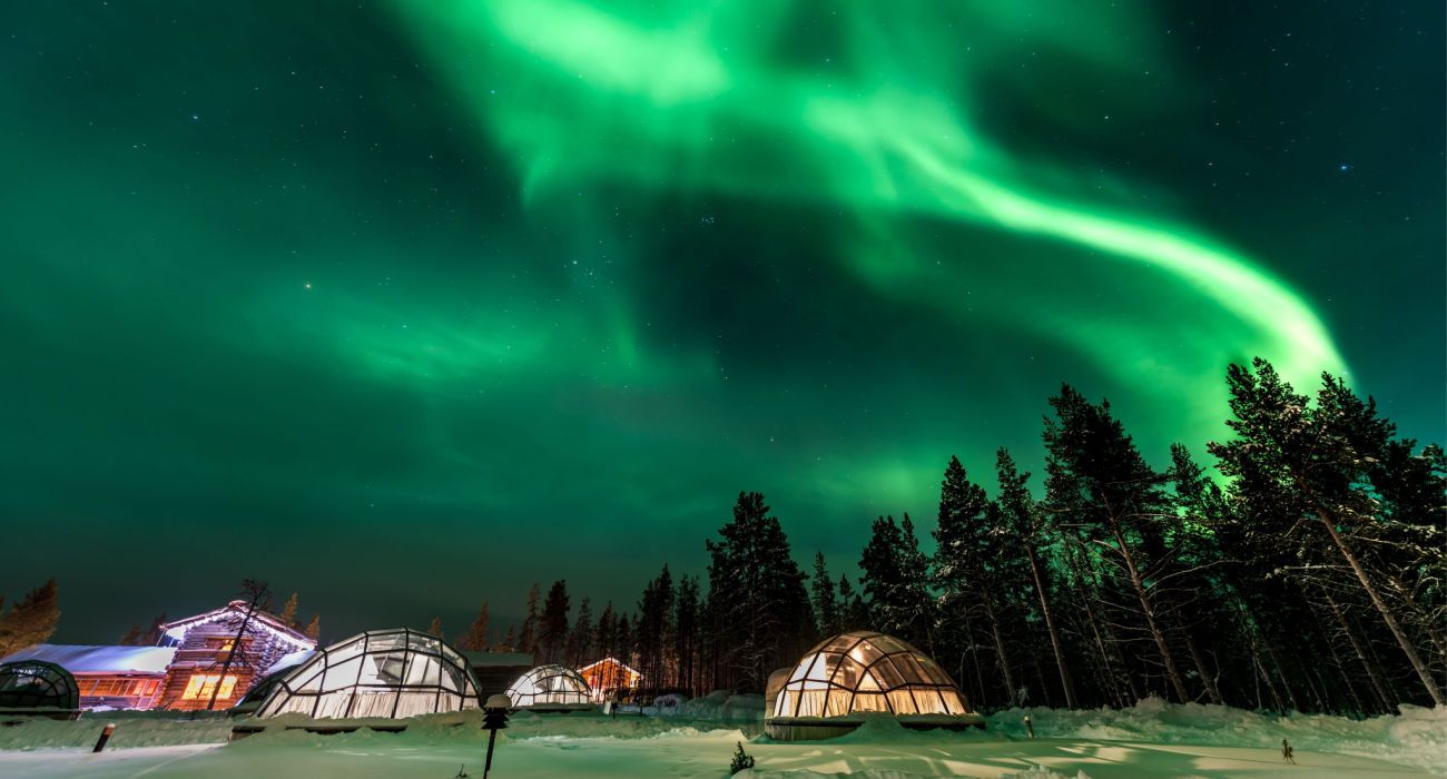 aurora above igloo house in Finland