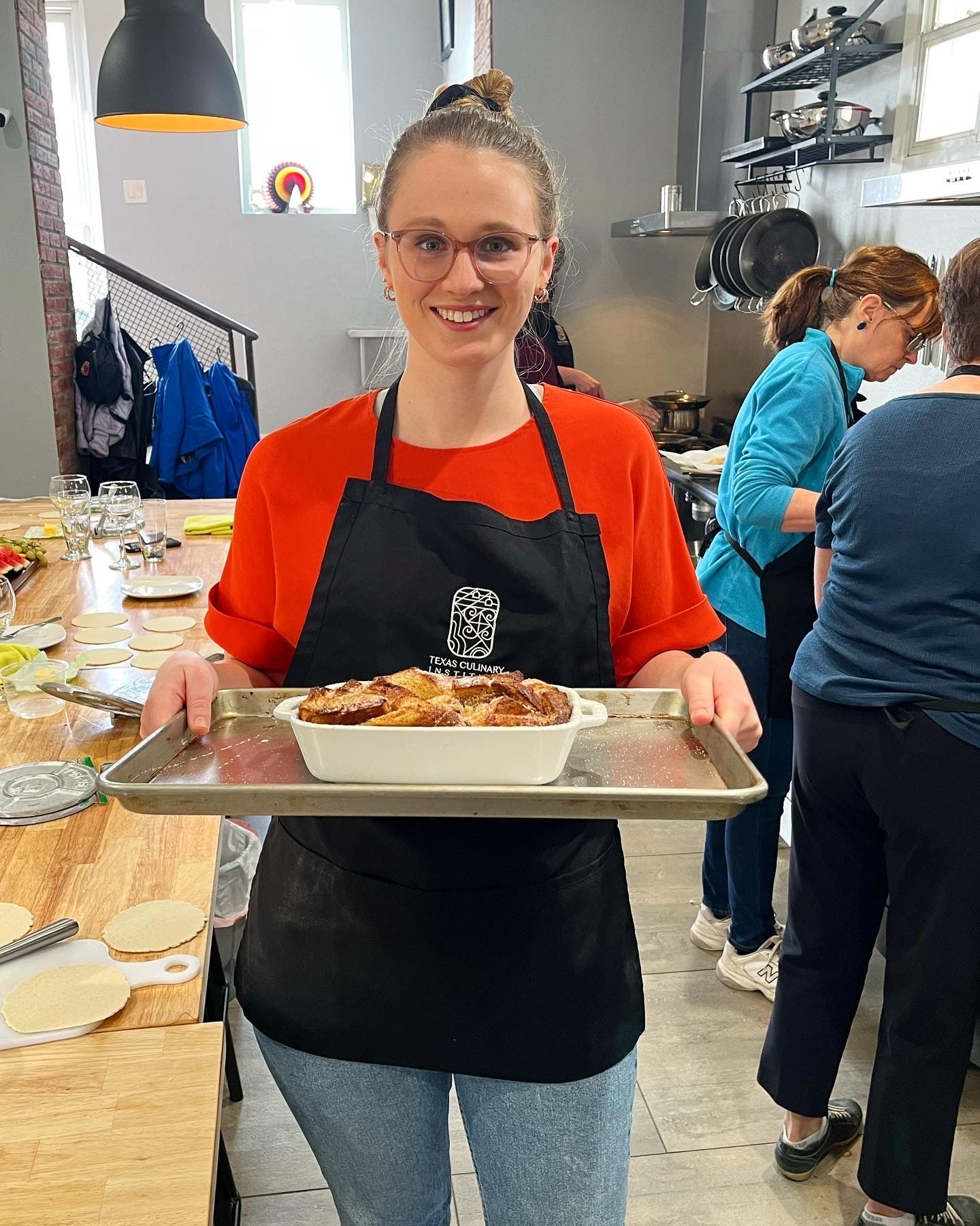 A student holds up their creation at Texas Culinary Insitute