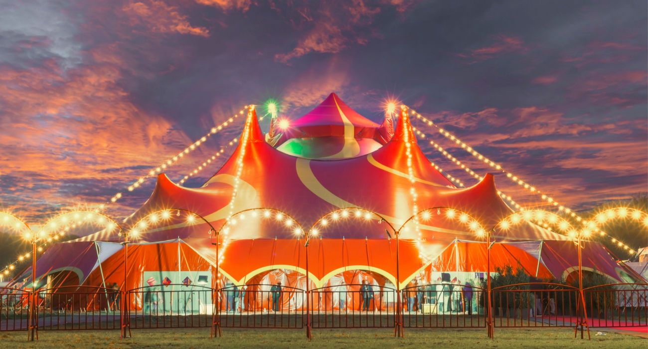 Circus tent under a warm sunset and chaotic sky