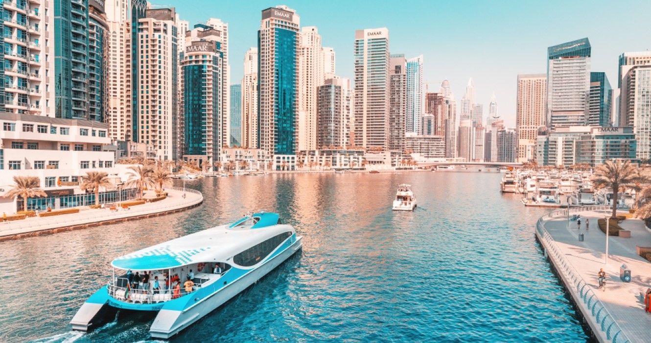 Cruise ferry boat sailing in Dubai Marina harbor