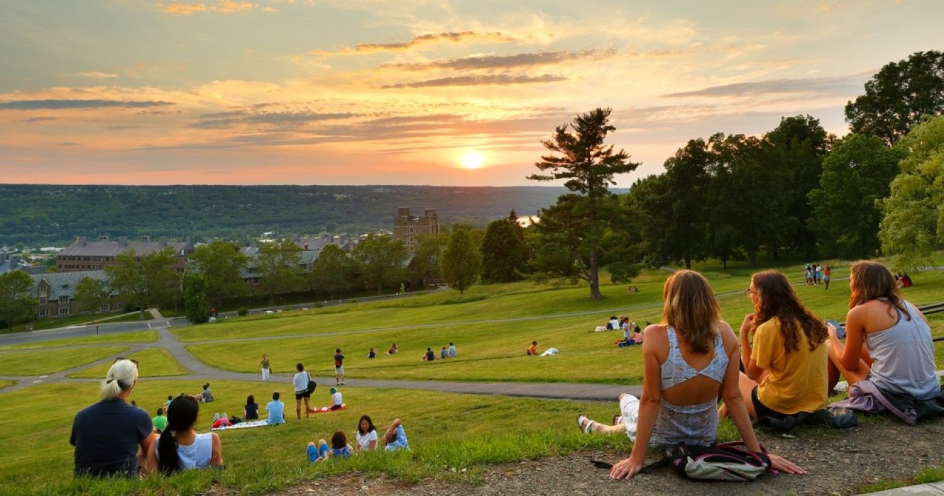 Students at Libe Slope watching sunset on campus of Cornell University, Ithaca, New York