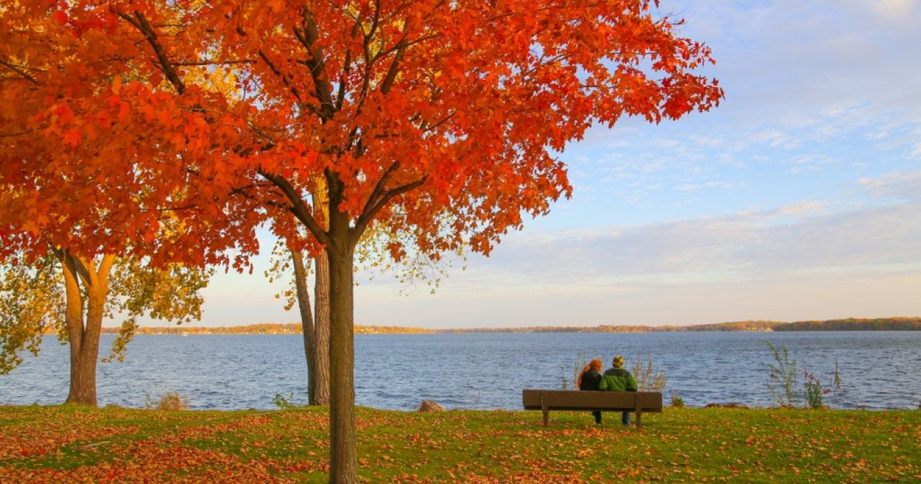 Couple sitting together in front of lake in Wisconsin