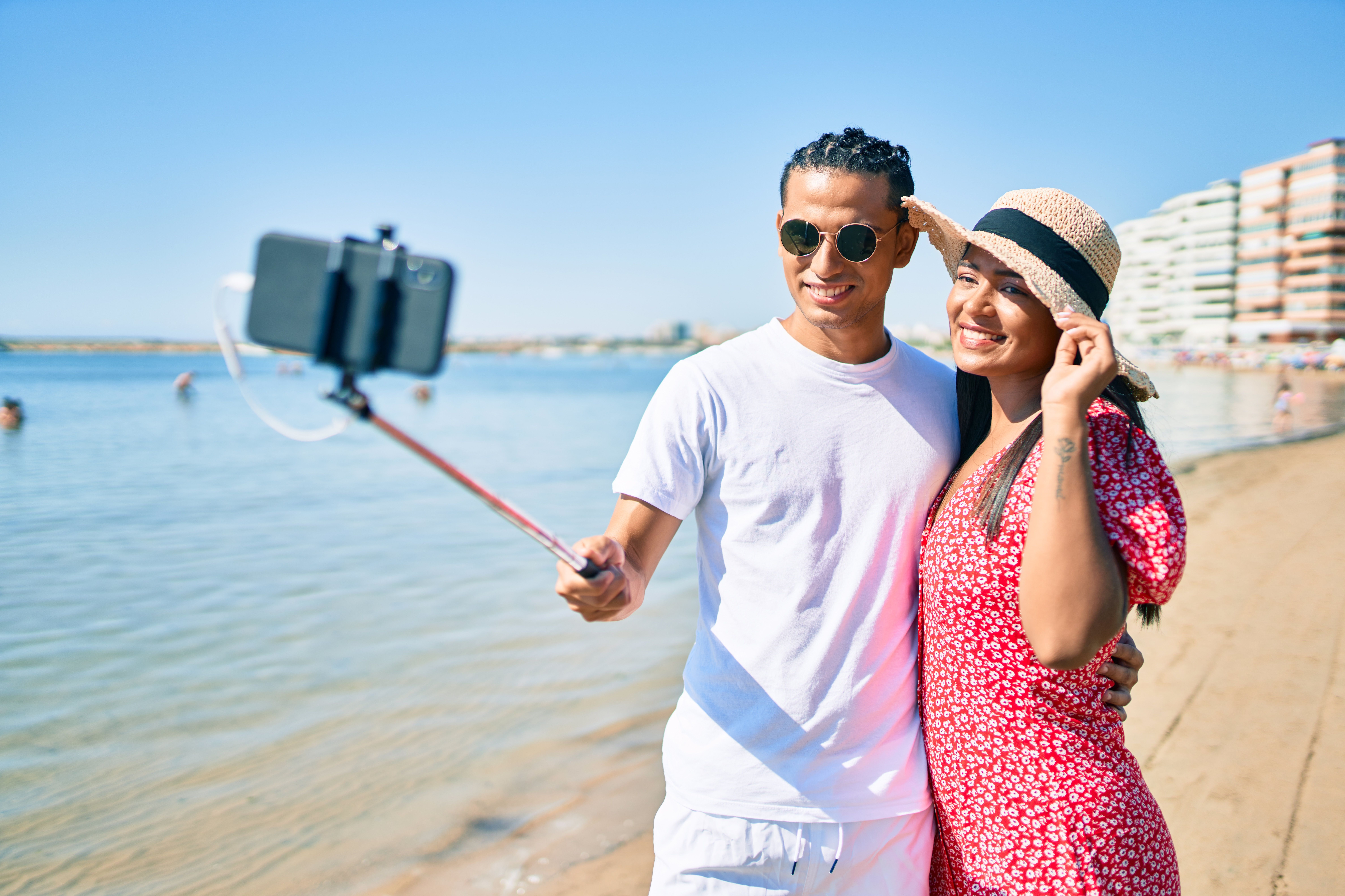 couple taking a vacation selfie on beach