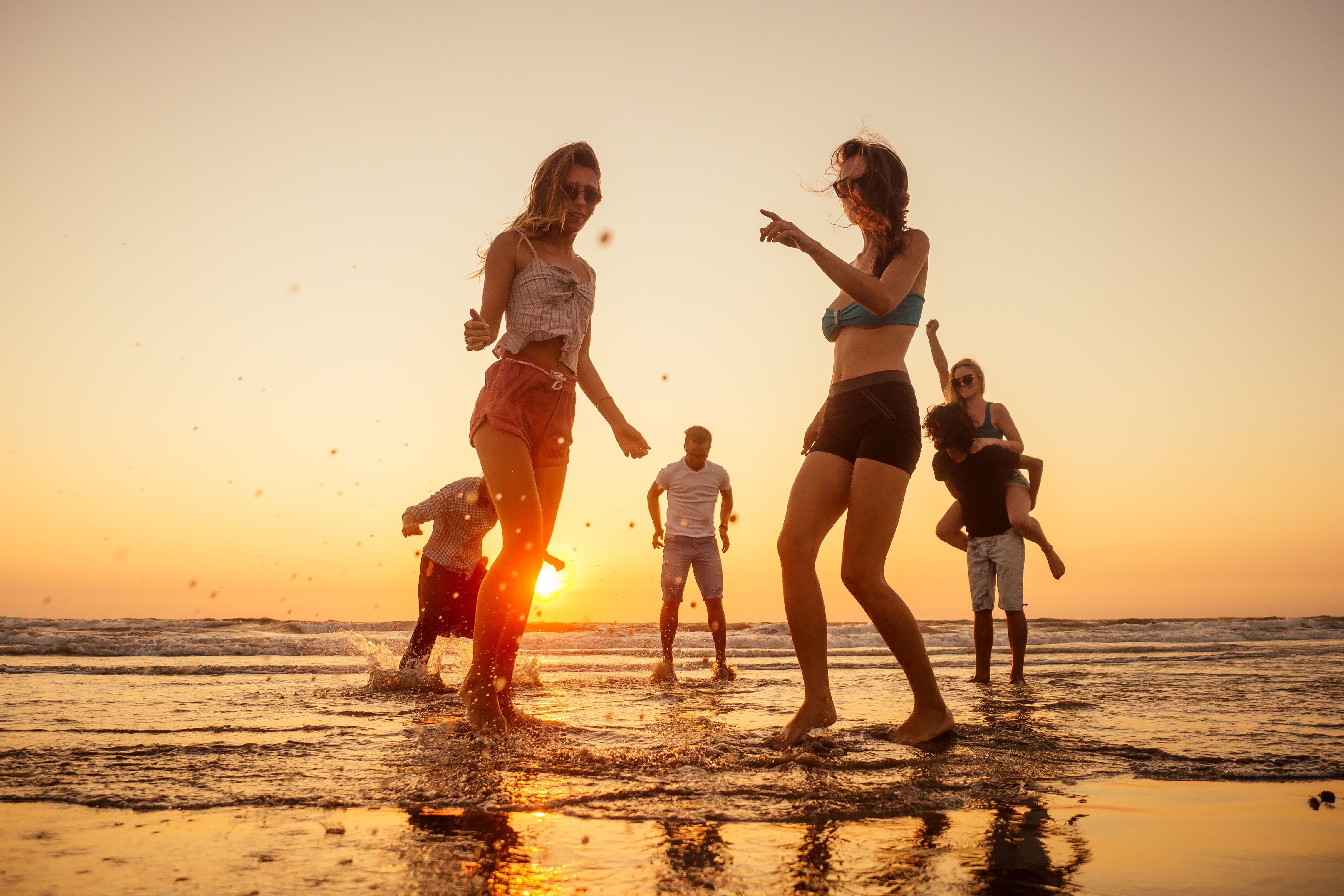 friends at beach jumping