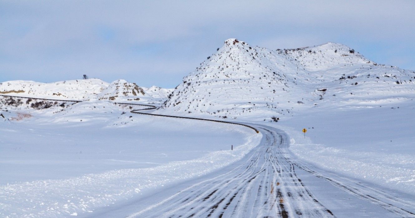Snow covered road thru North Dakota badlands