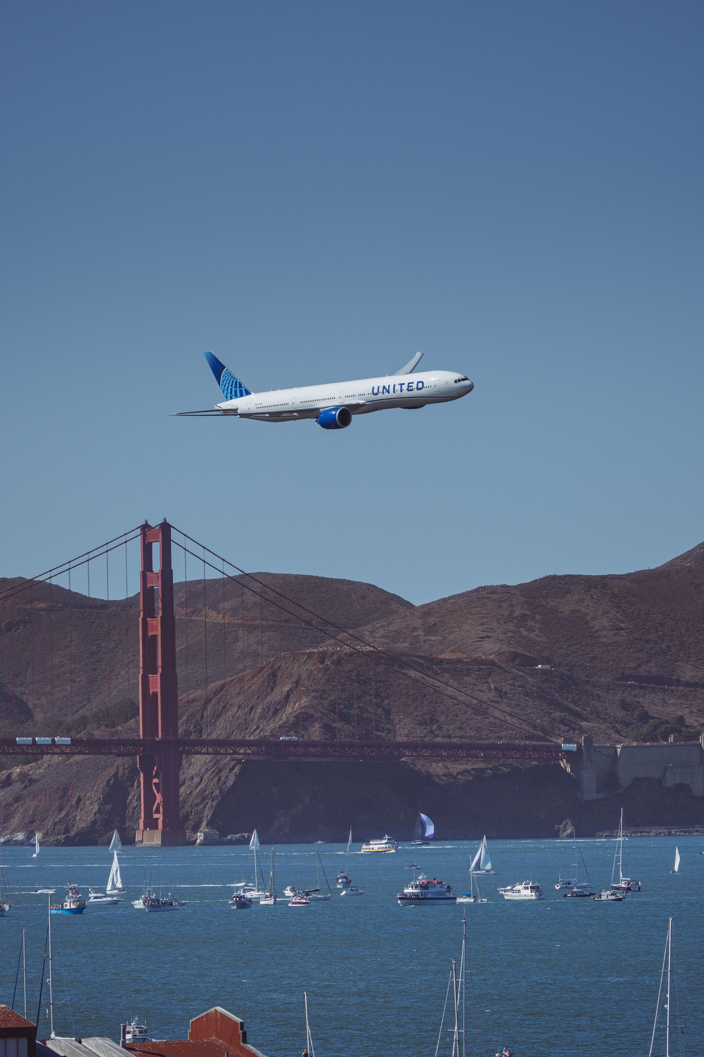 United Airlines flying over the Golden Gate Bridge