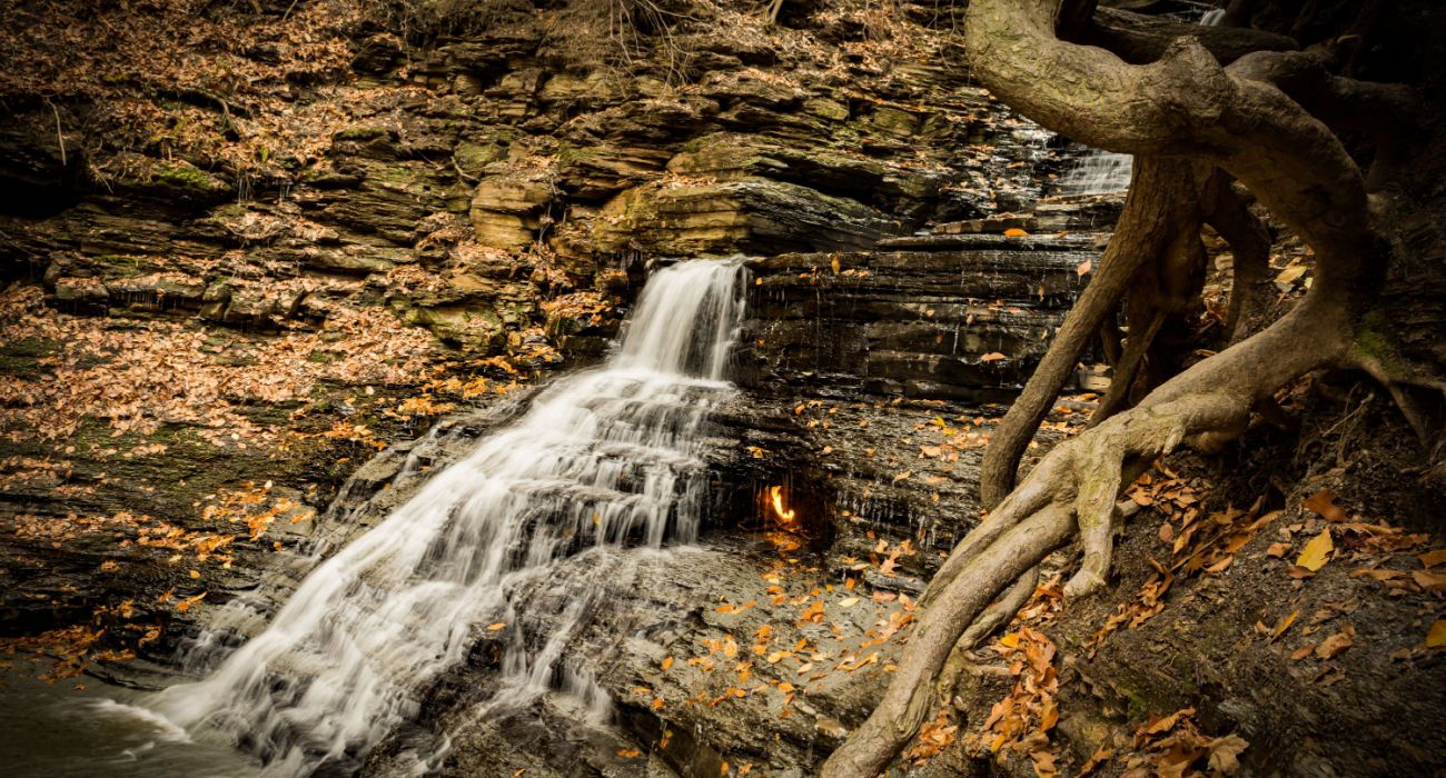 A flame inside of a waterfall At Eternal Flame Falls