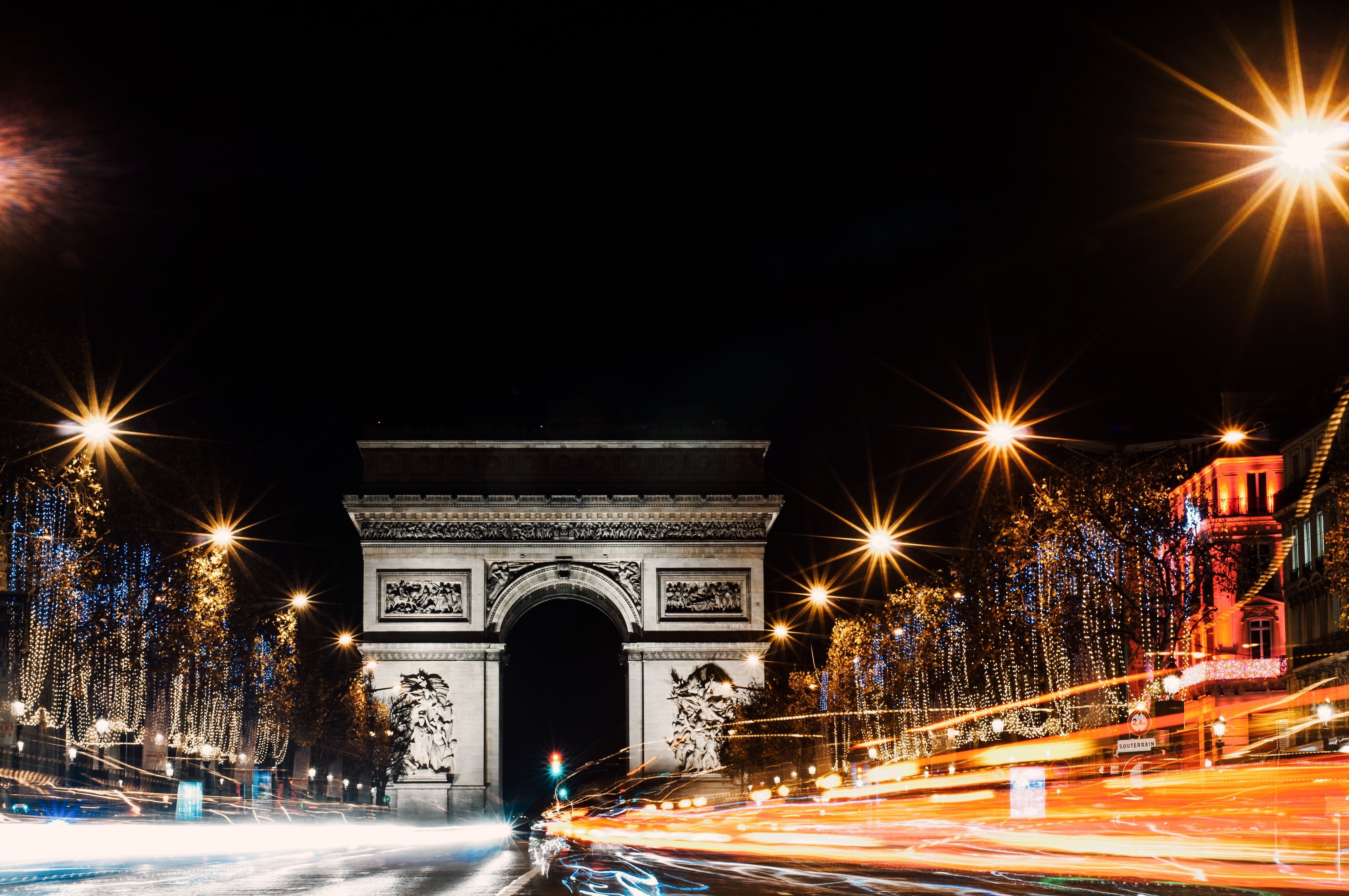 Avenue des Champs-Élysées at night with the Arc de Triomph in the background