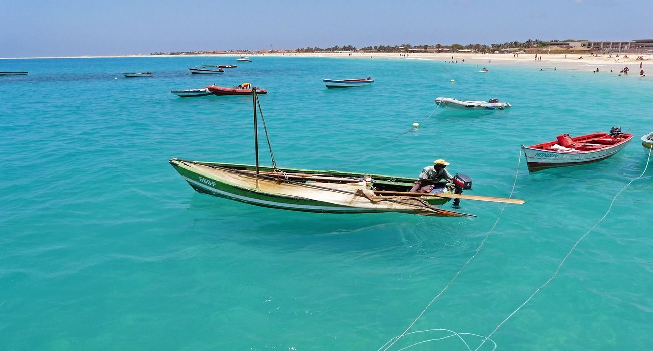 Fishermen and Boats In Cape Verde And Beach
