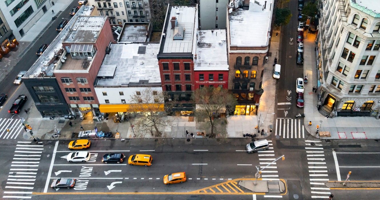 Overhead view of New York City street scene with taxis driving down Bowery past the buildings of the Nolita neighborhood in Manhattan NYC