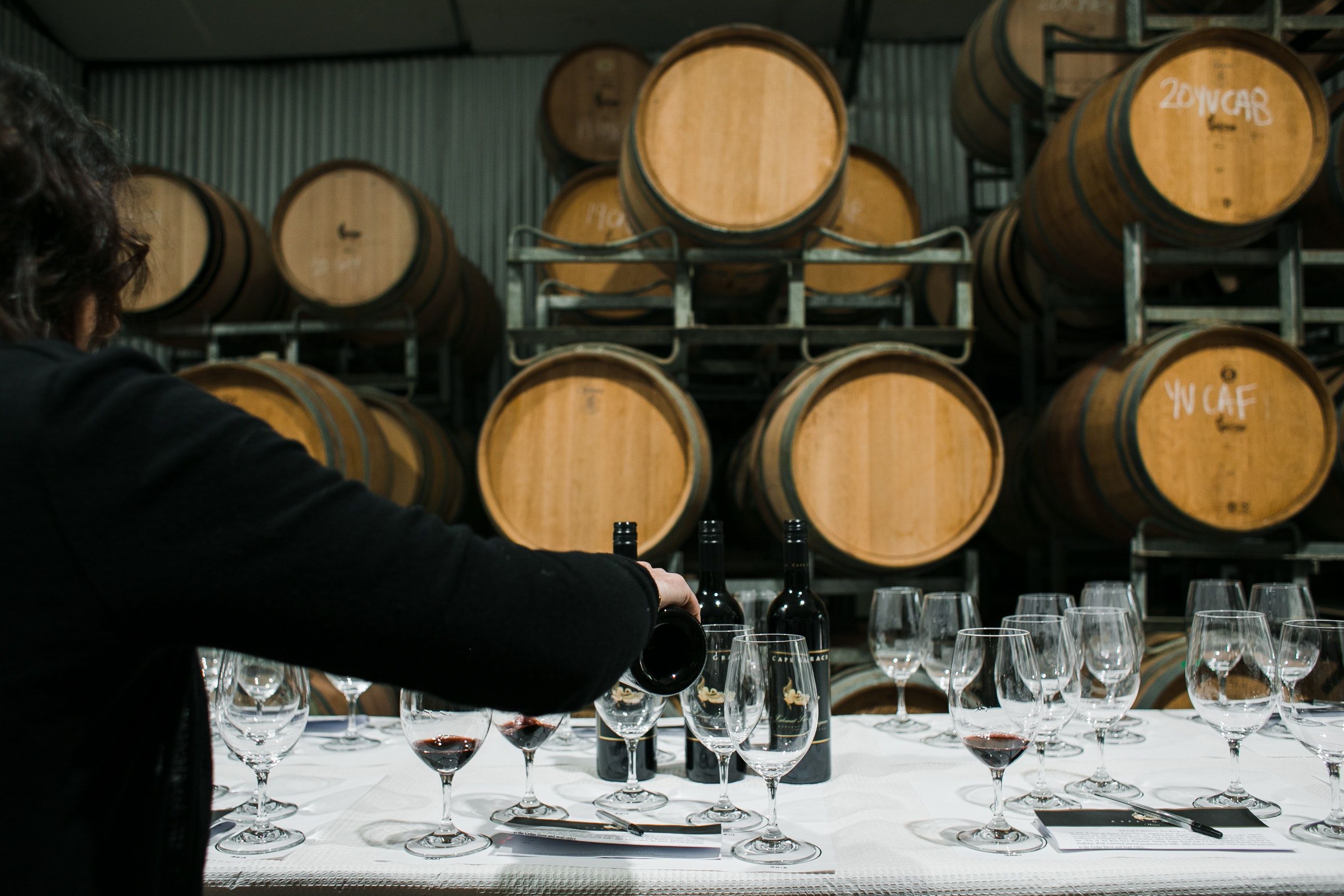 A Man In A Wine Crypt Pours Wine