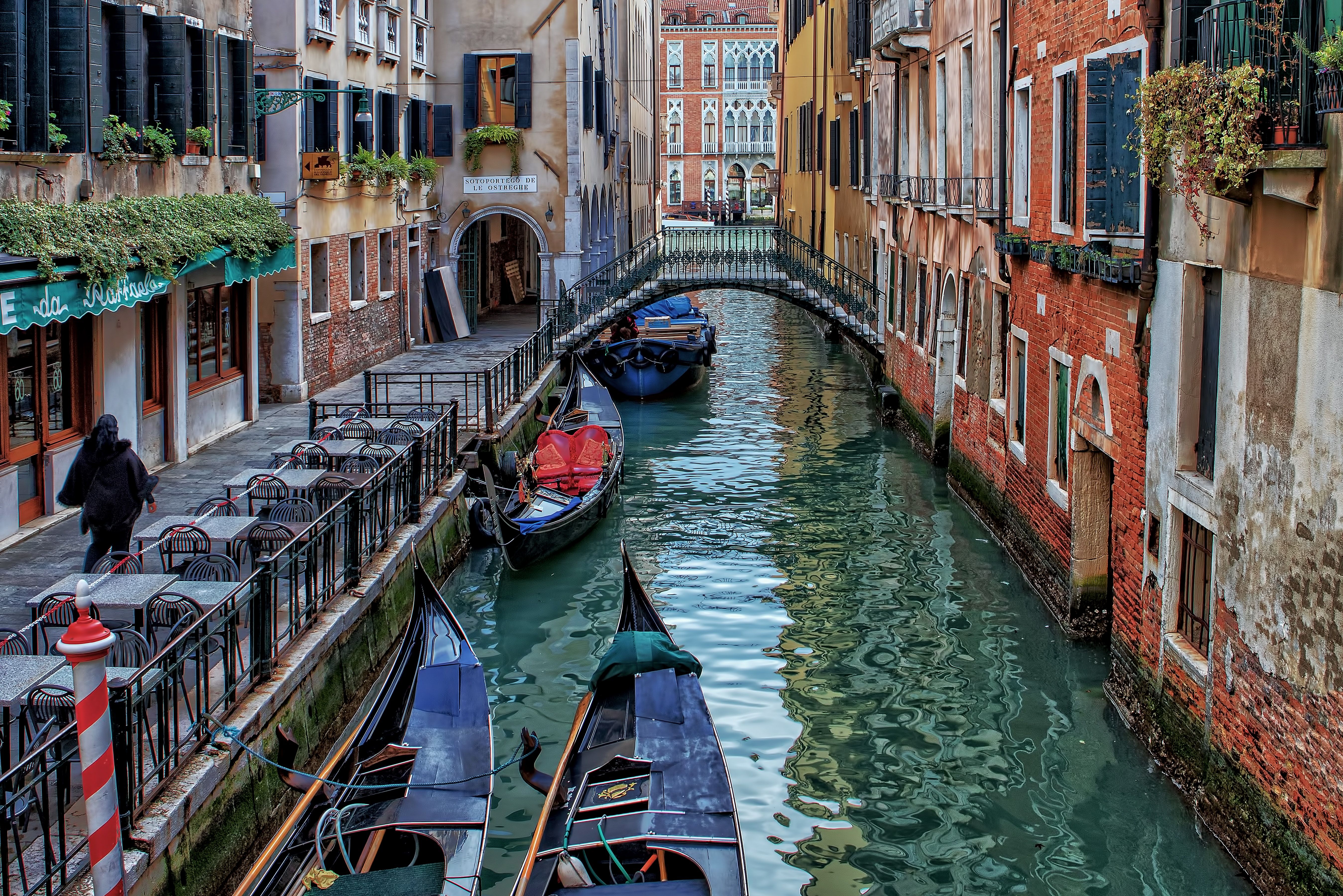 Boats line a colorful canal in Venice.