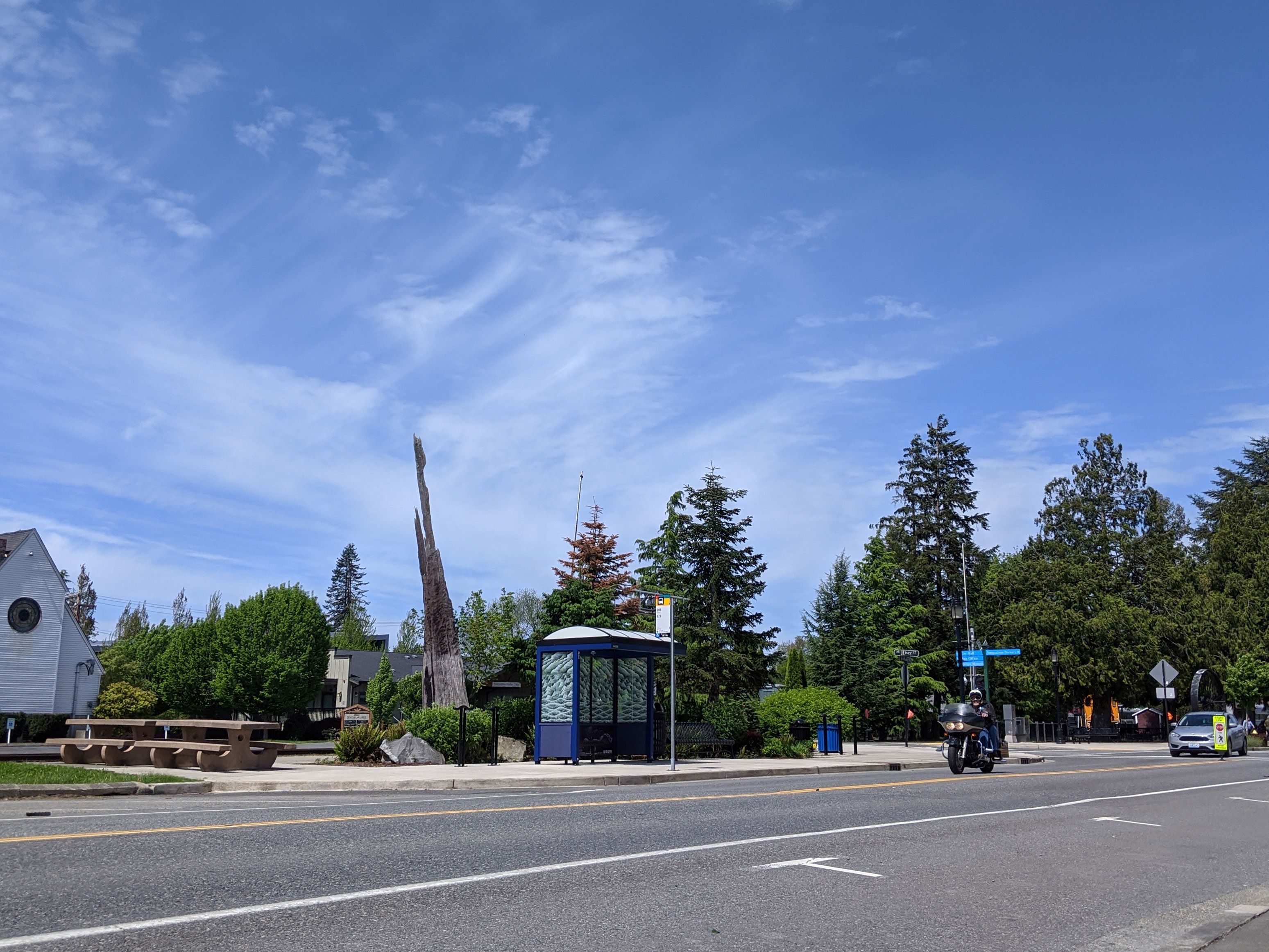 Snoqualmie, WA USA - circa May 2020: Street view of an empty metro bus stop on a bright, sunny day downtown