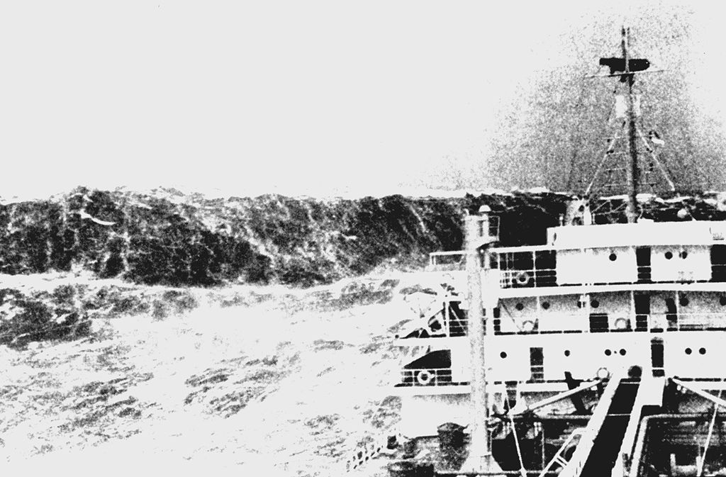 A merchant ship in the Bay of Biscay circa 1940 labors in violent seas as a huge rogue wave appears ahead