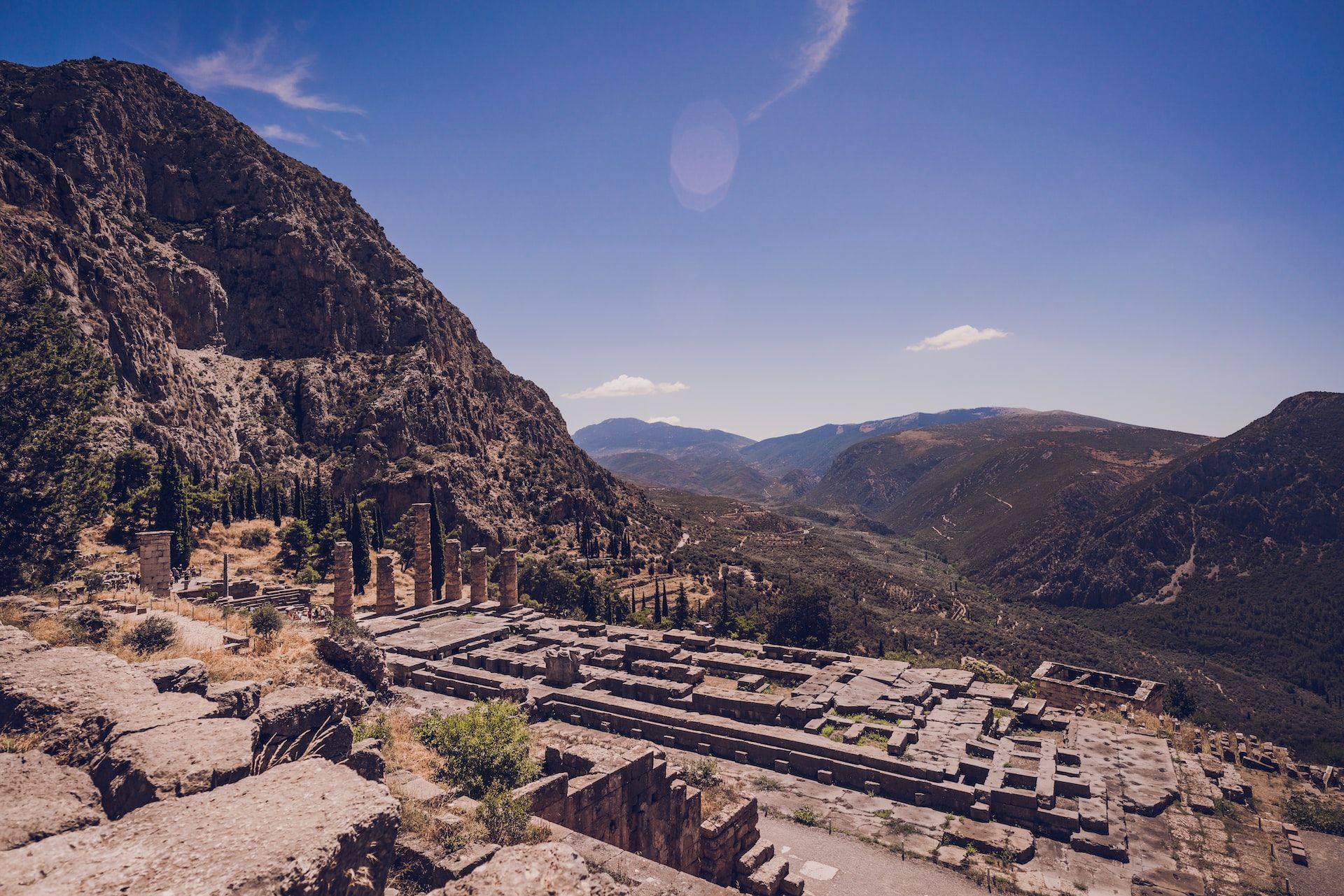 The ancient ruins at Delphi, Greece, against a dramatic backdrops of undulating hills and valleys