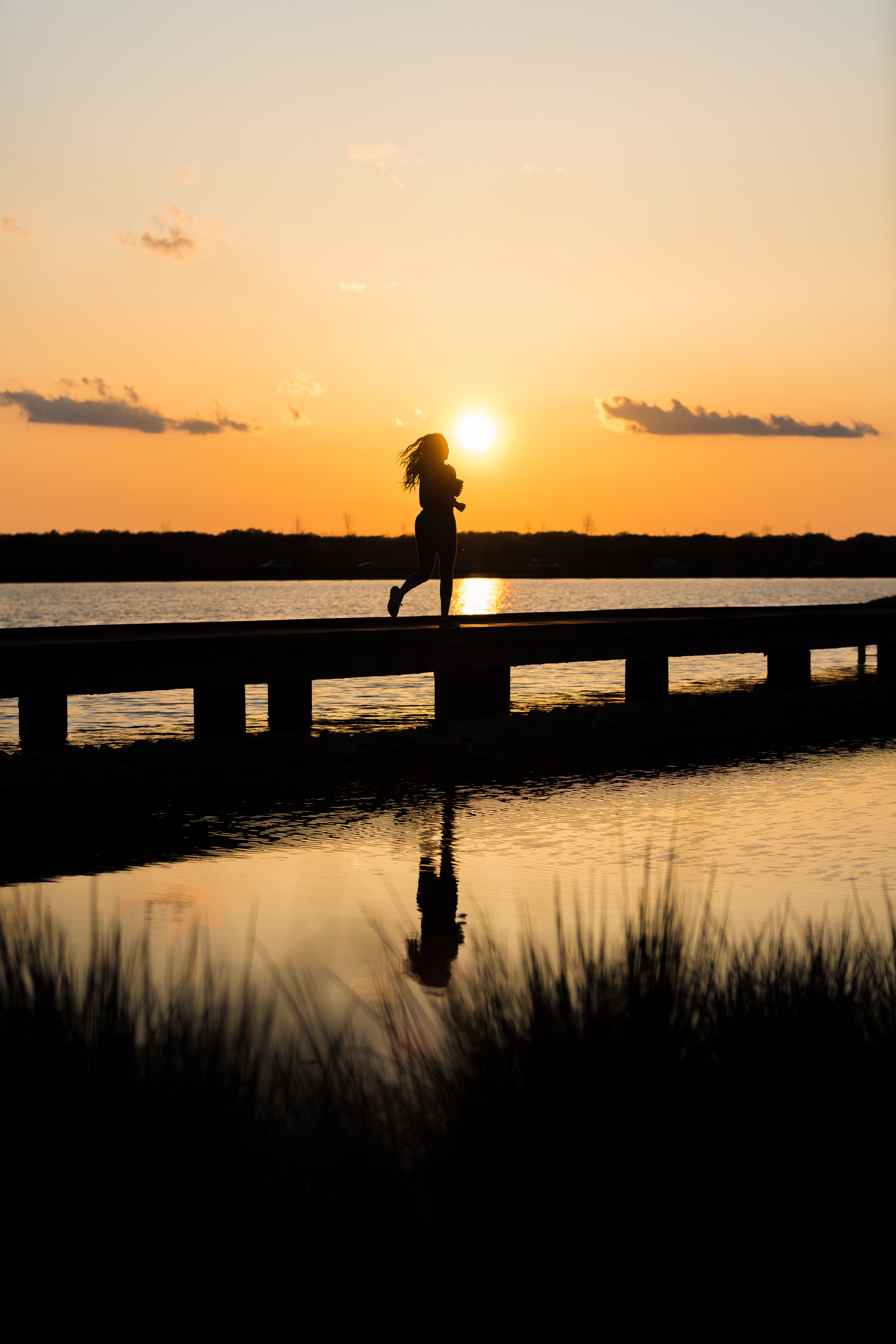 A person running along a boardwalk at sunset at Shelby Farms Park, Memphis