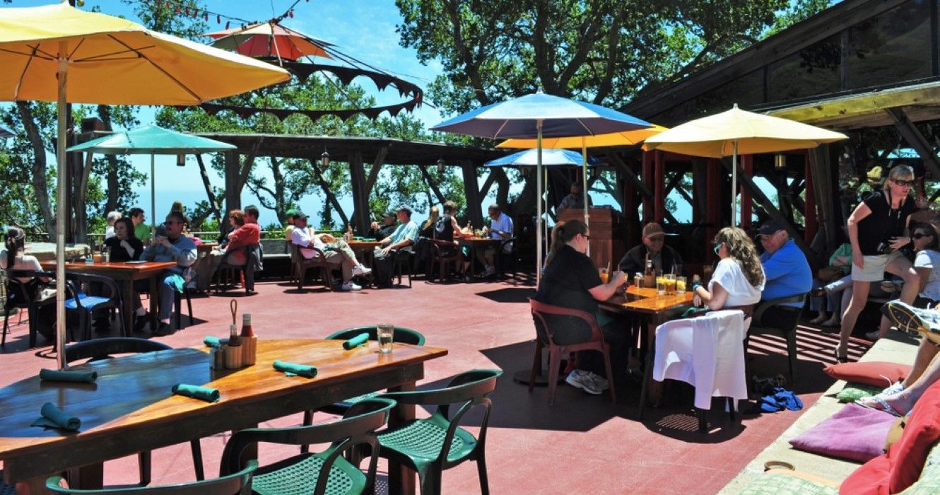People eating outdoors at Nepenthe Restaurant in Big Sur, California
