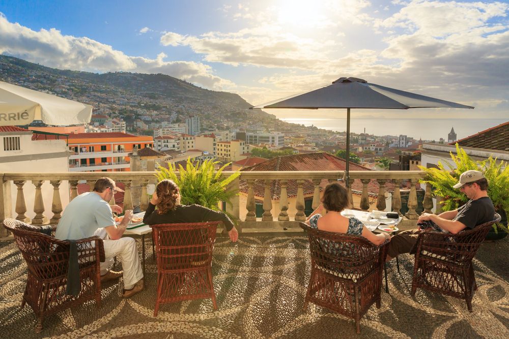 People having breakfast on the terrace of their hotel in Funchal, Madeira