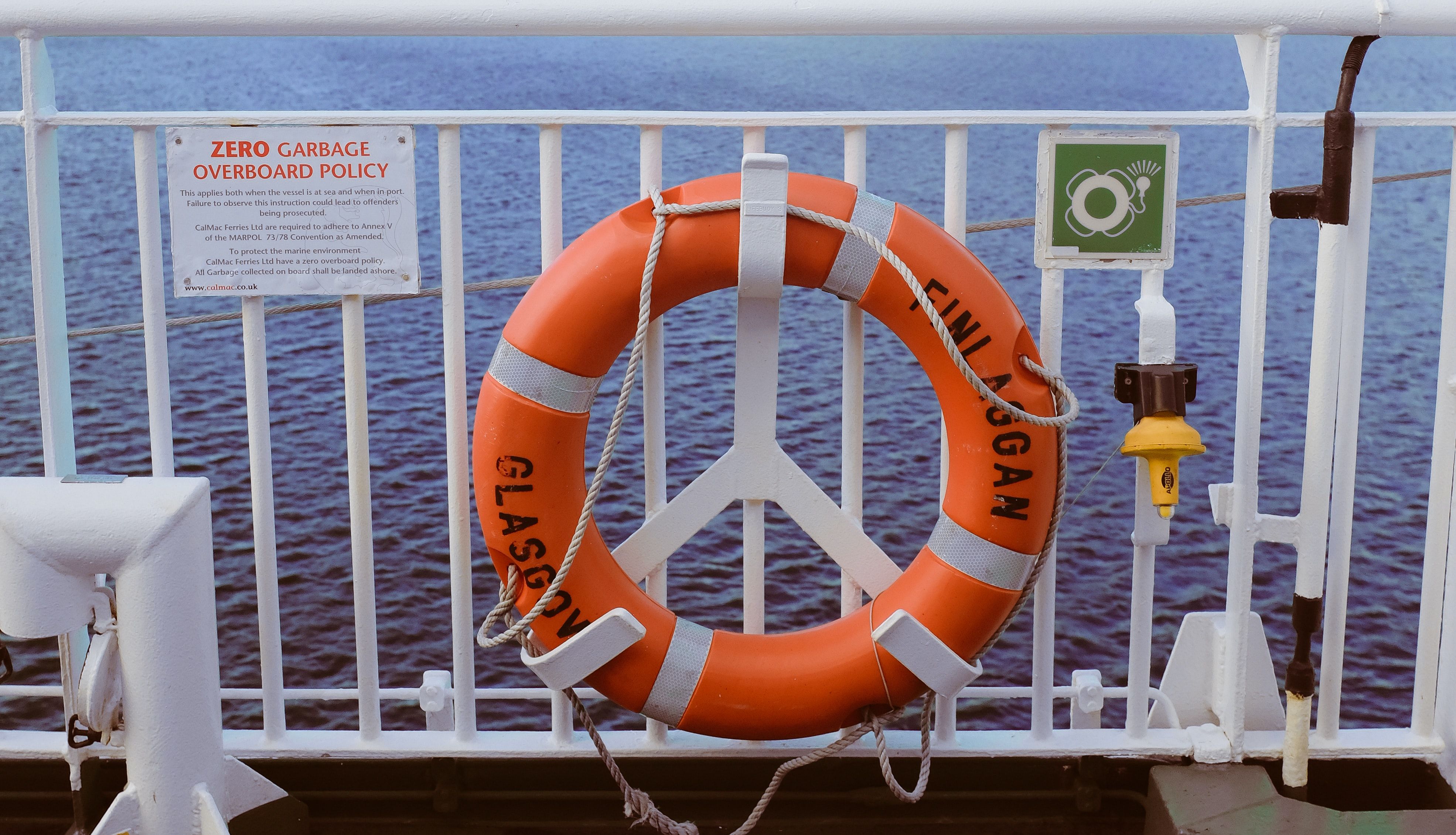 Photo of ring buoy next to vessel policy signage