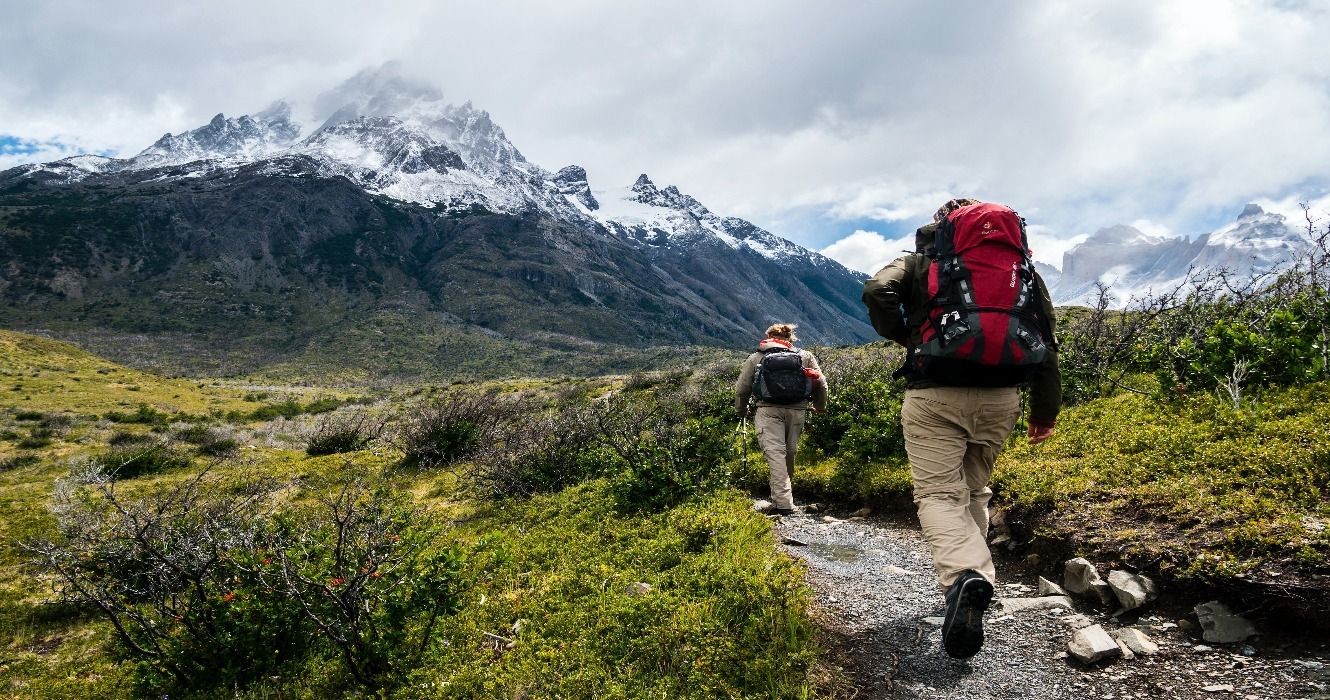 Backpackers hiking the W Trek in Chile, with beautiful mountains in the background