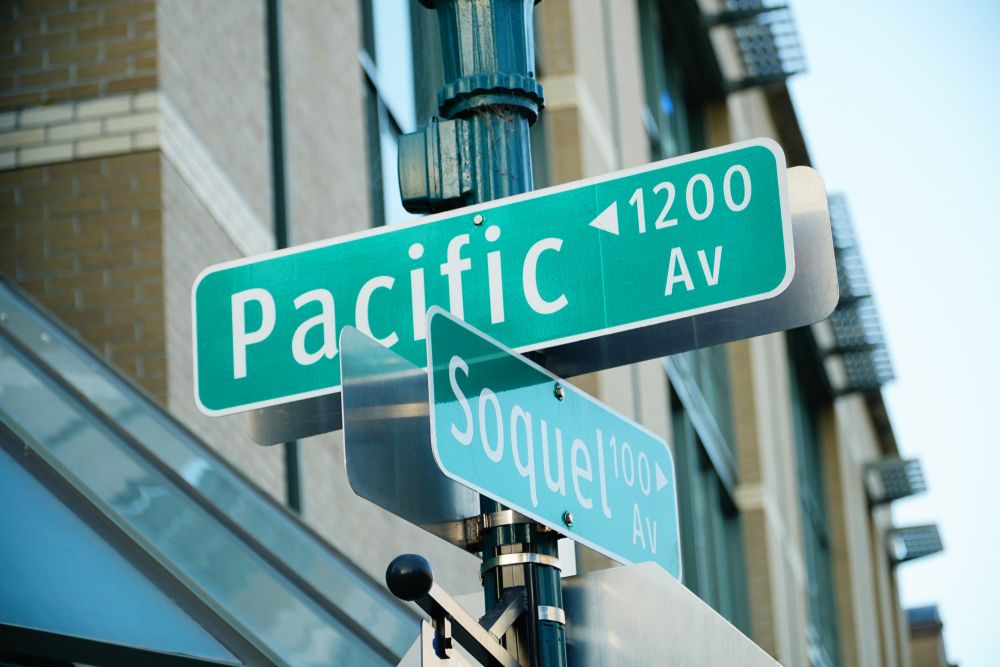 Street signs showing the crossroads at Pacific Avenue and Soquel. 