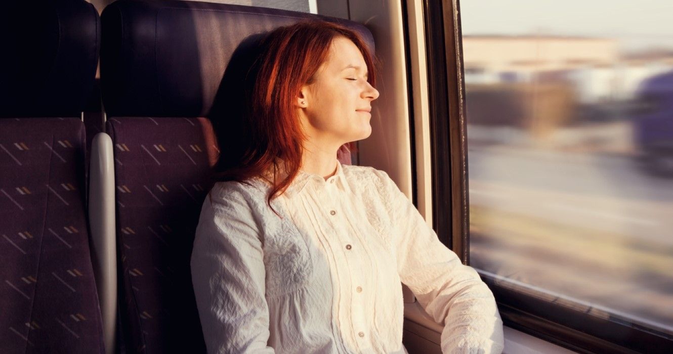 Young woman traveling comfortably in train