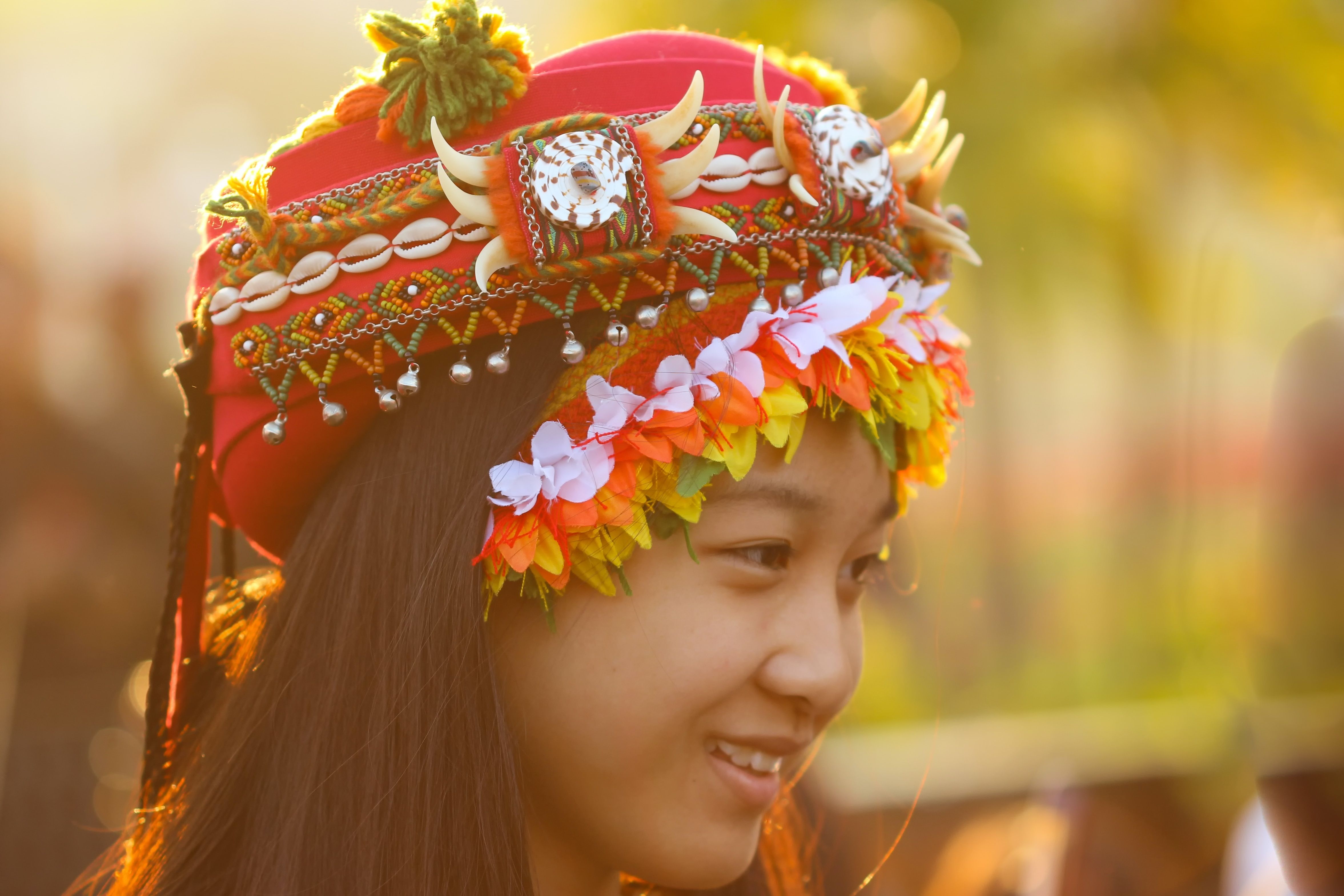 A woman wearing a tribal head dress in Kaohsiung