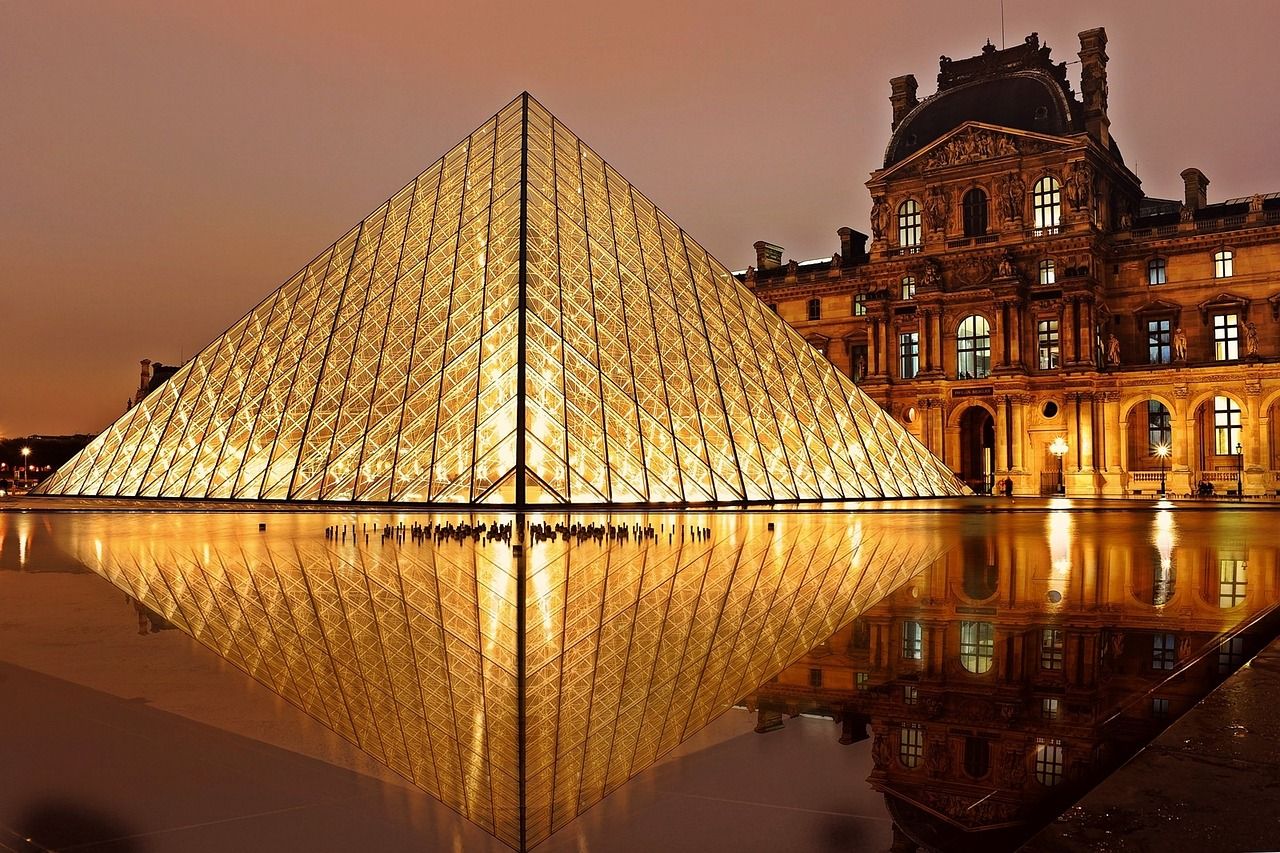 Pyramid at the Louvre during the night with beautiful golden lights