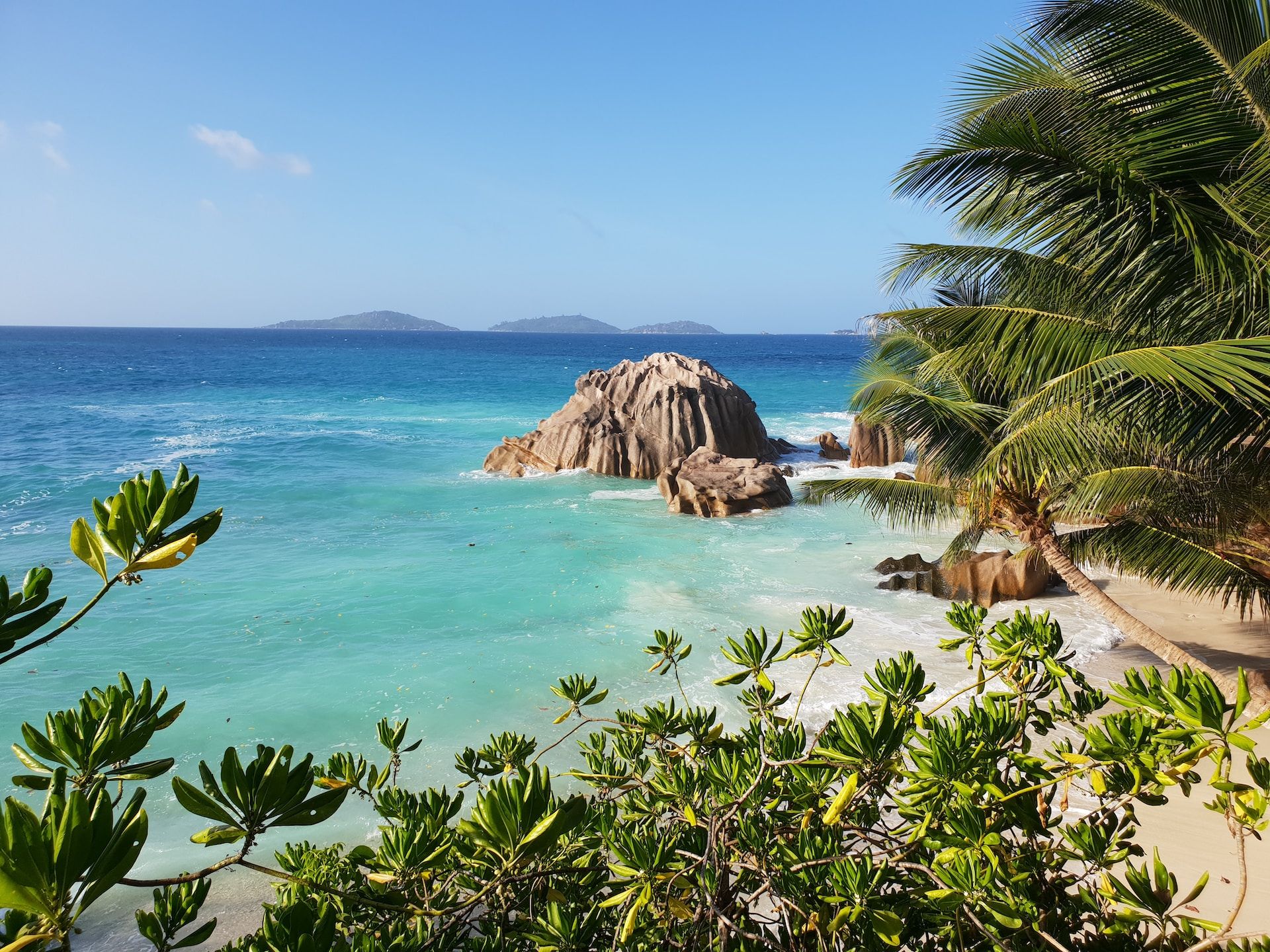 Beautiful island, blue ocean, and green trees in La Digue island in the Seychelles