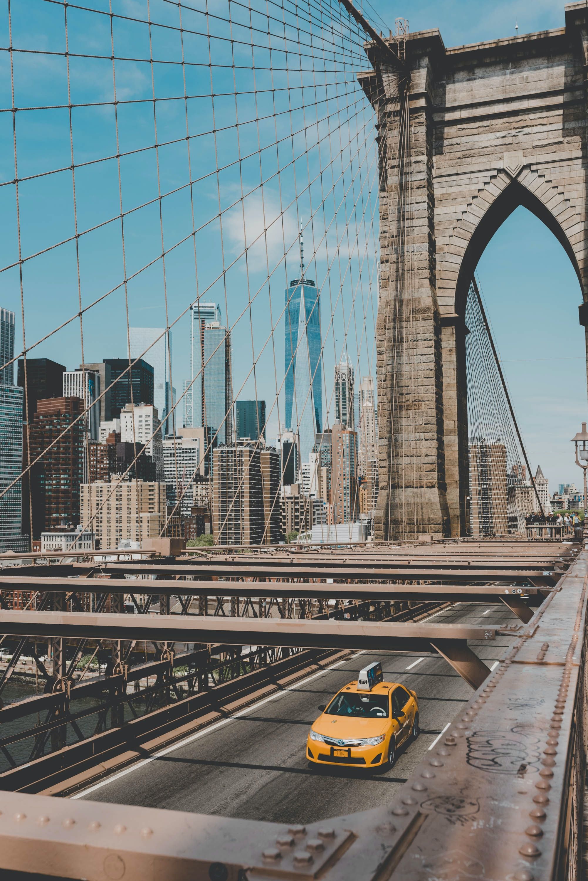 A taxi driving across the Brooklyn Bridge, NYC