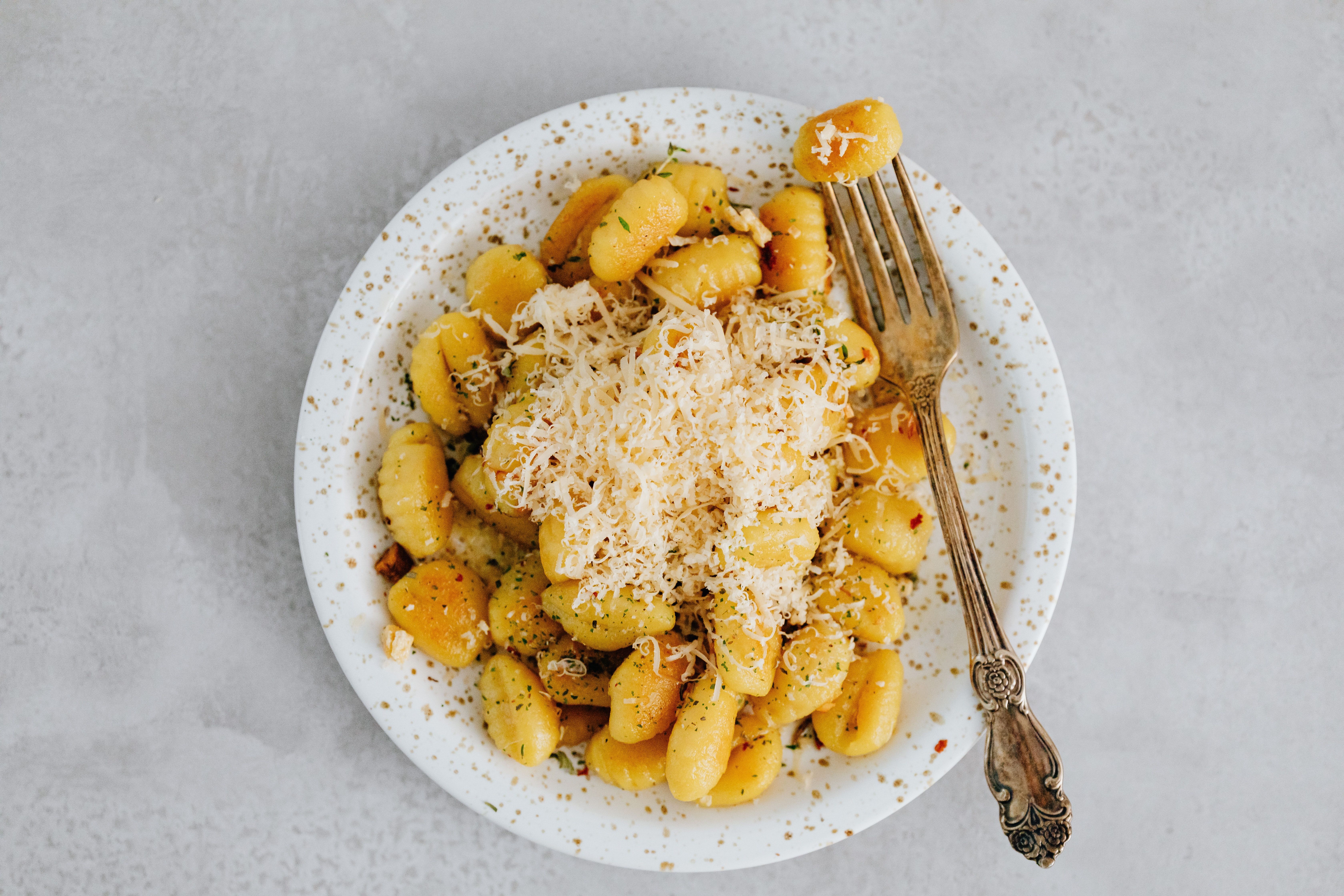 Gnocchi on a Ceramic Plate with Fork on the Side