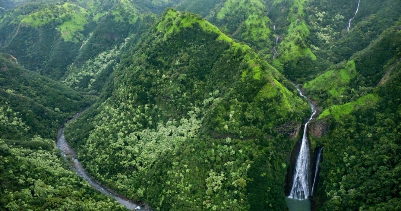 Manawaiopuna Falls in Kauai, Hawaii, or the waterfalls from Jurassic Park, seen from a helicopter